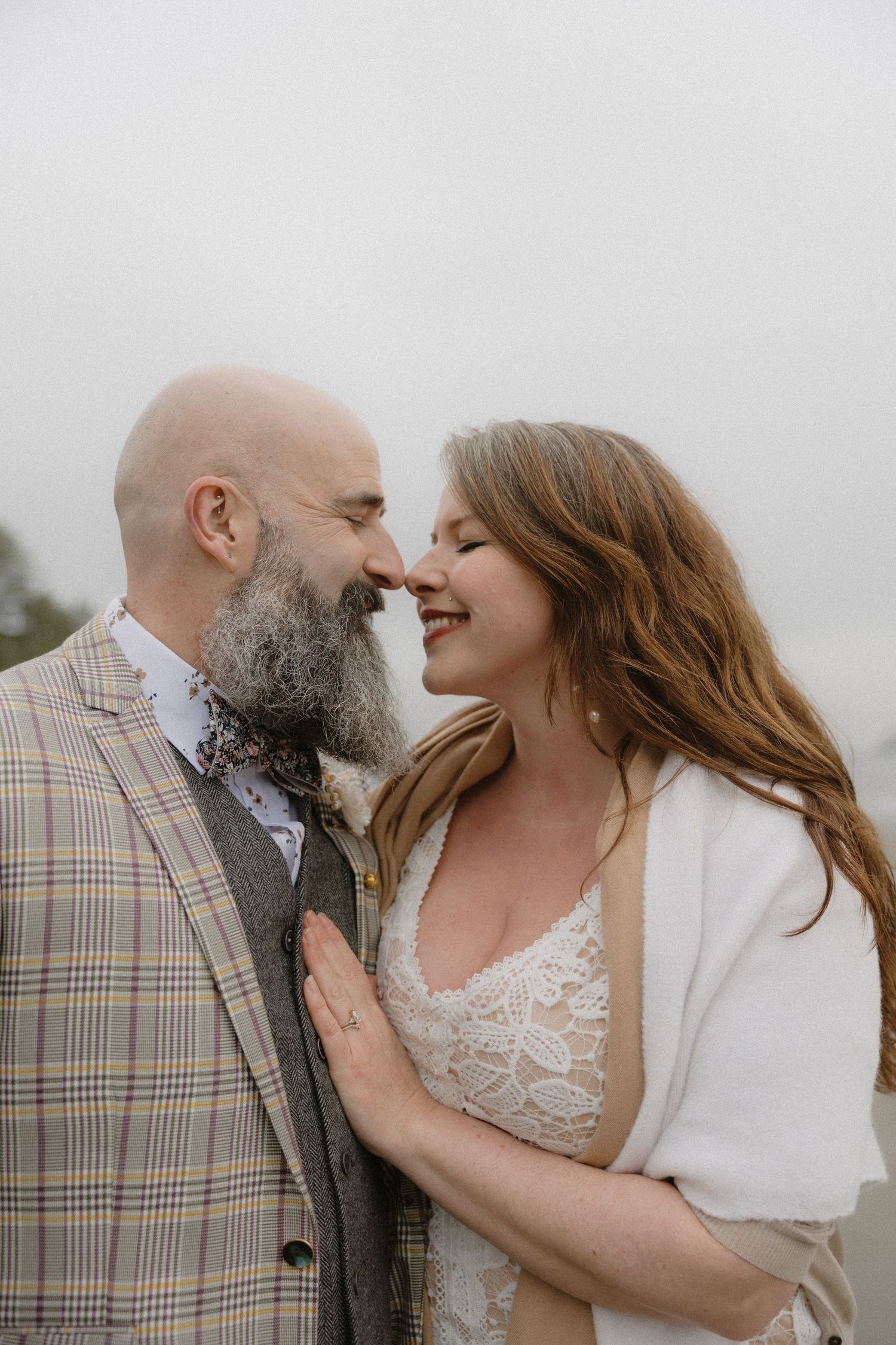 A romantic wedding couple shares intimate moments in a series of candid photos against a light background.