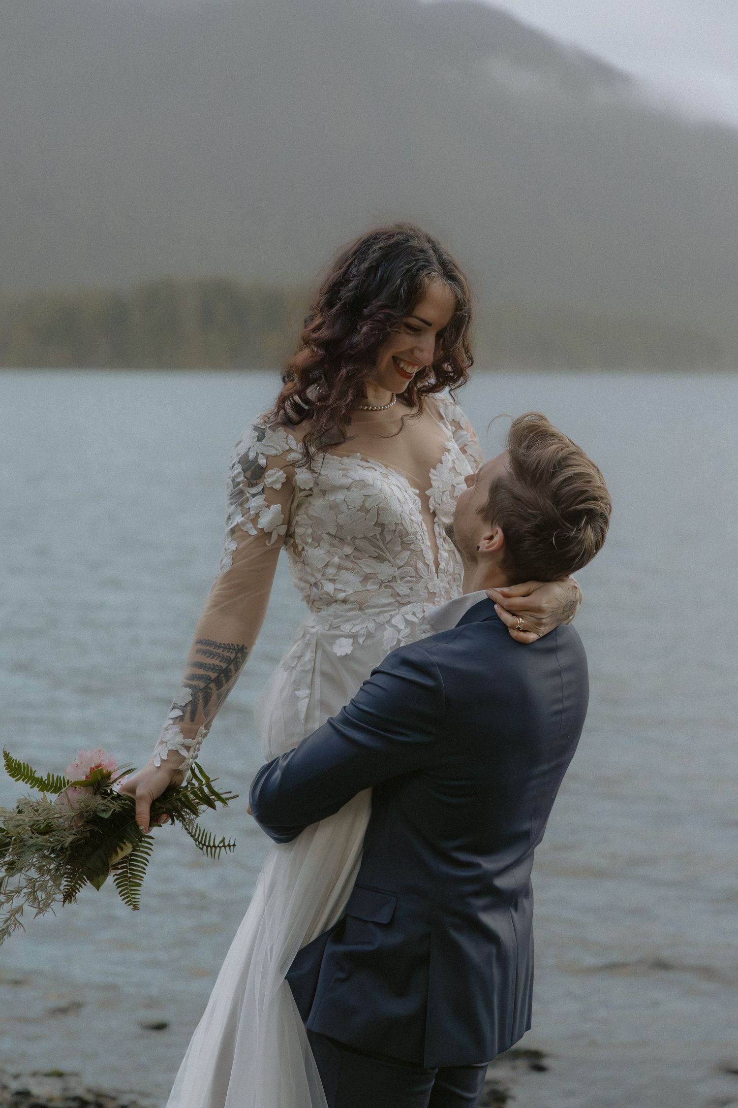 Tofino bride and groom in Pacific Rim twirling and holding wildflower bouquet