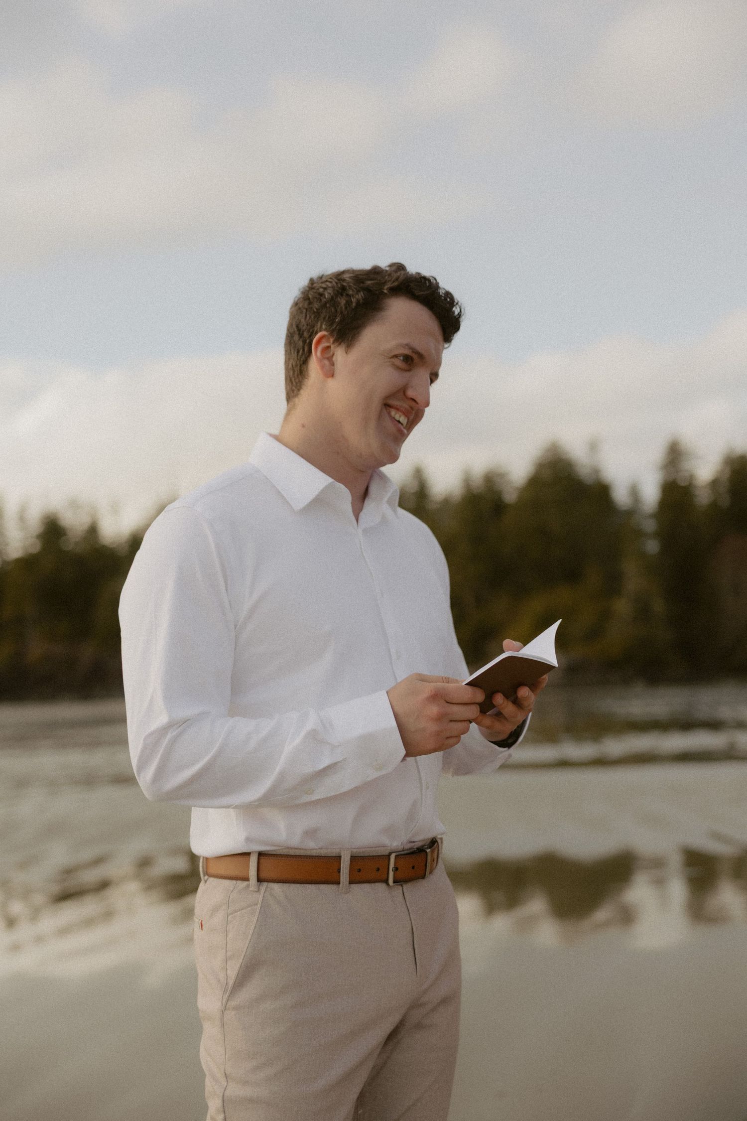 Groom reading his wedding vows on Mackenzie Beach near Ucluelet