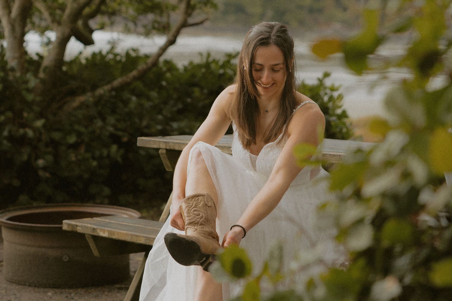 Tofino elopement bride getting ready at wooden table at Bella Pacifica Campground at Mackenzie Beach Tofino