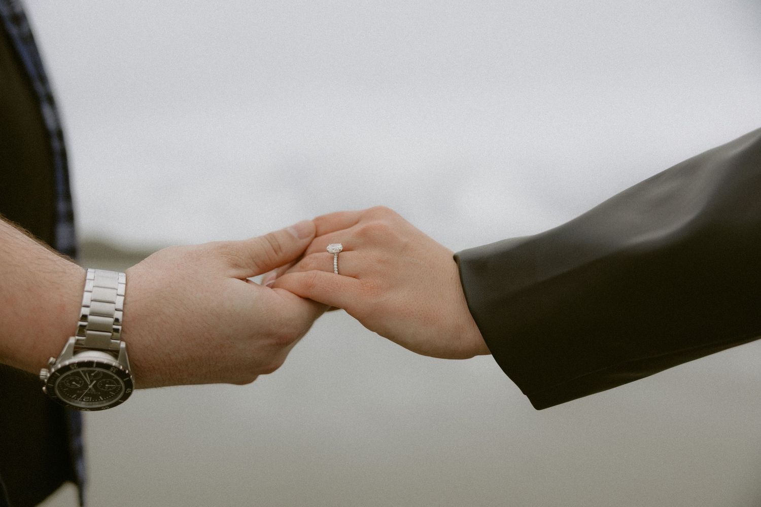 Tofino proposal couple holding hands with engagement ring