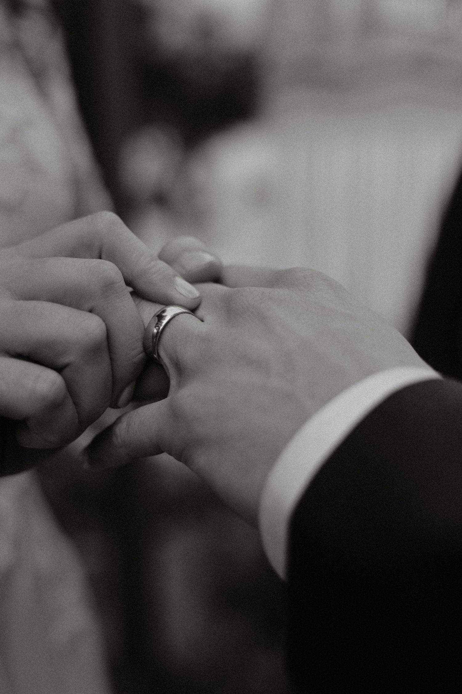 Tofino wedding black and white image of exchanging wedding rings during ceremony