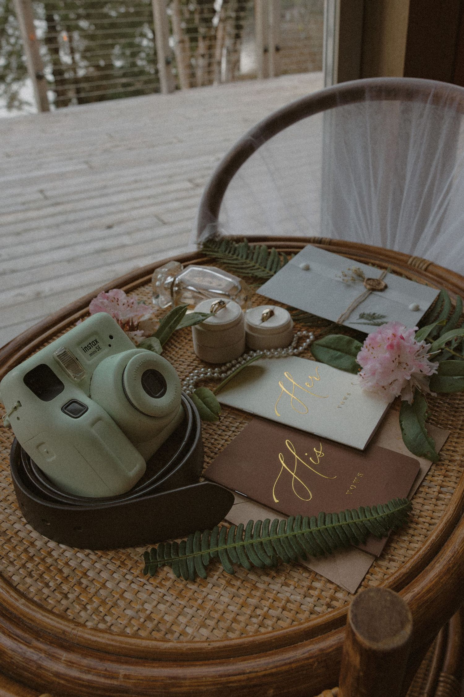 Tofino wedding table setting with green plates, woven charger, and wedding stationery