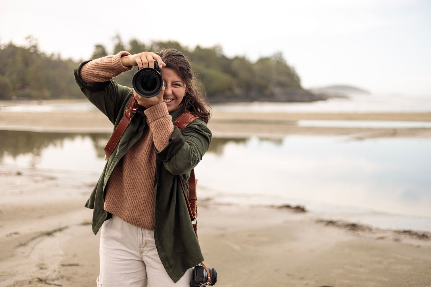 Tofino wedding photographer Mariana with her camera on Mackenzie Beach Tofino