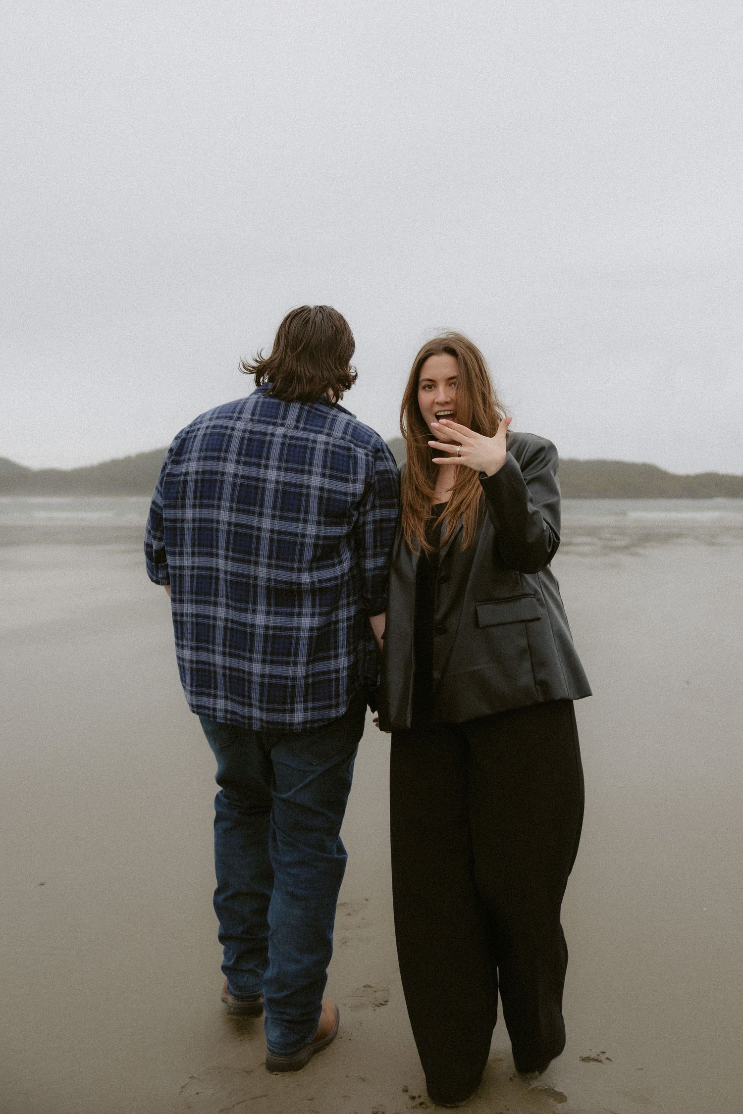 Vancouver Island couple sharing tender moments together on a Chesterman Beach