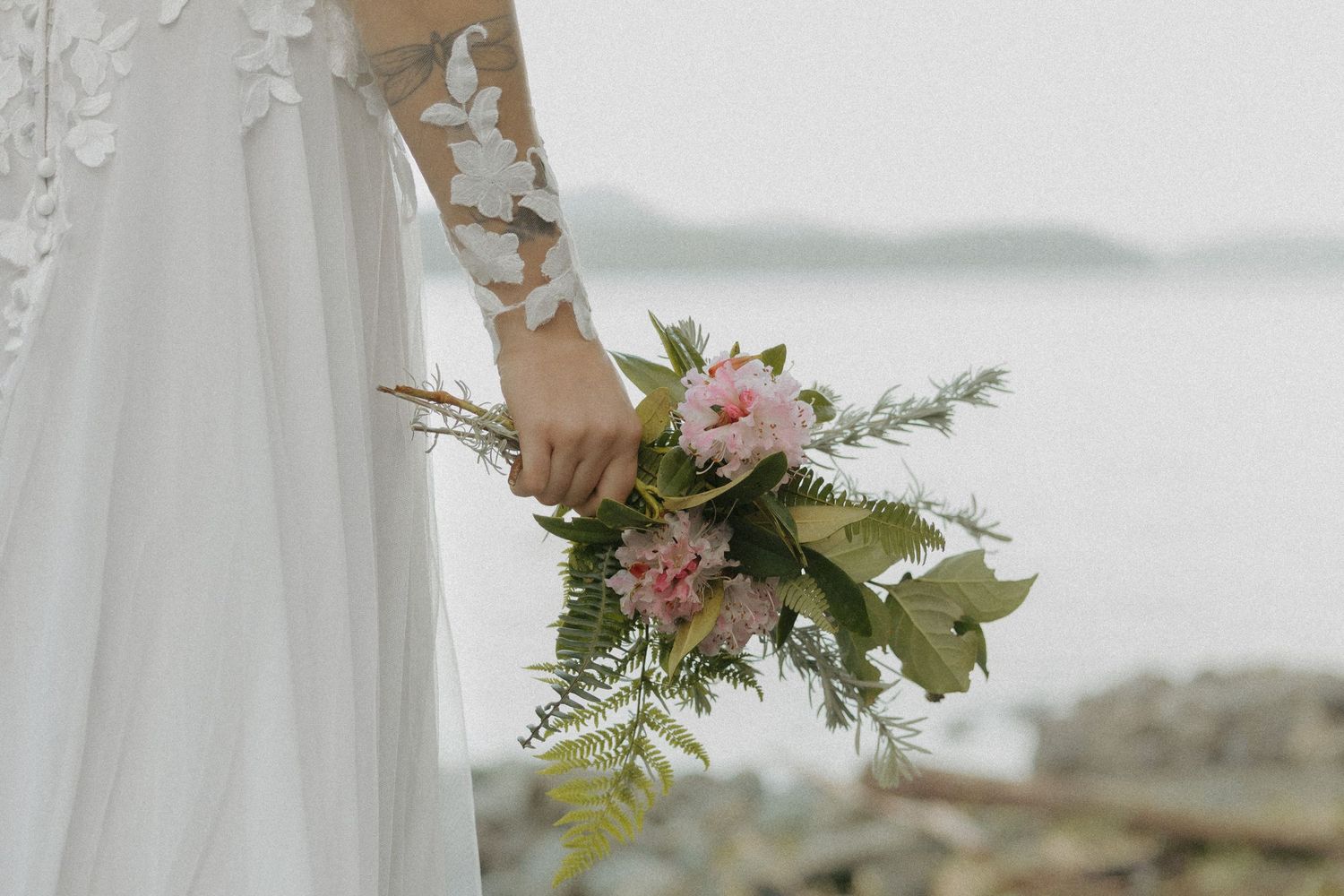 Tofino wedding bride holding a bouquet full of wildflowers