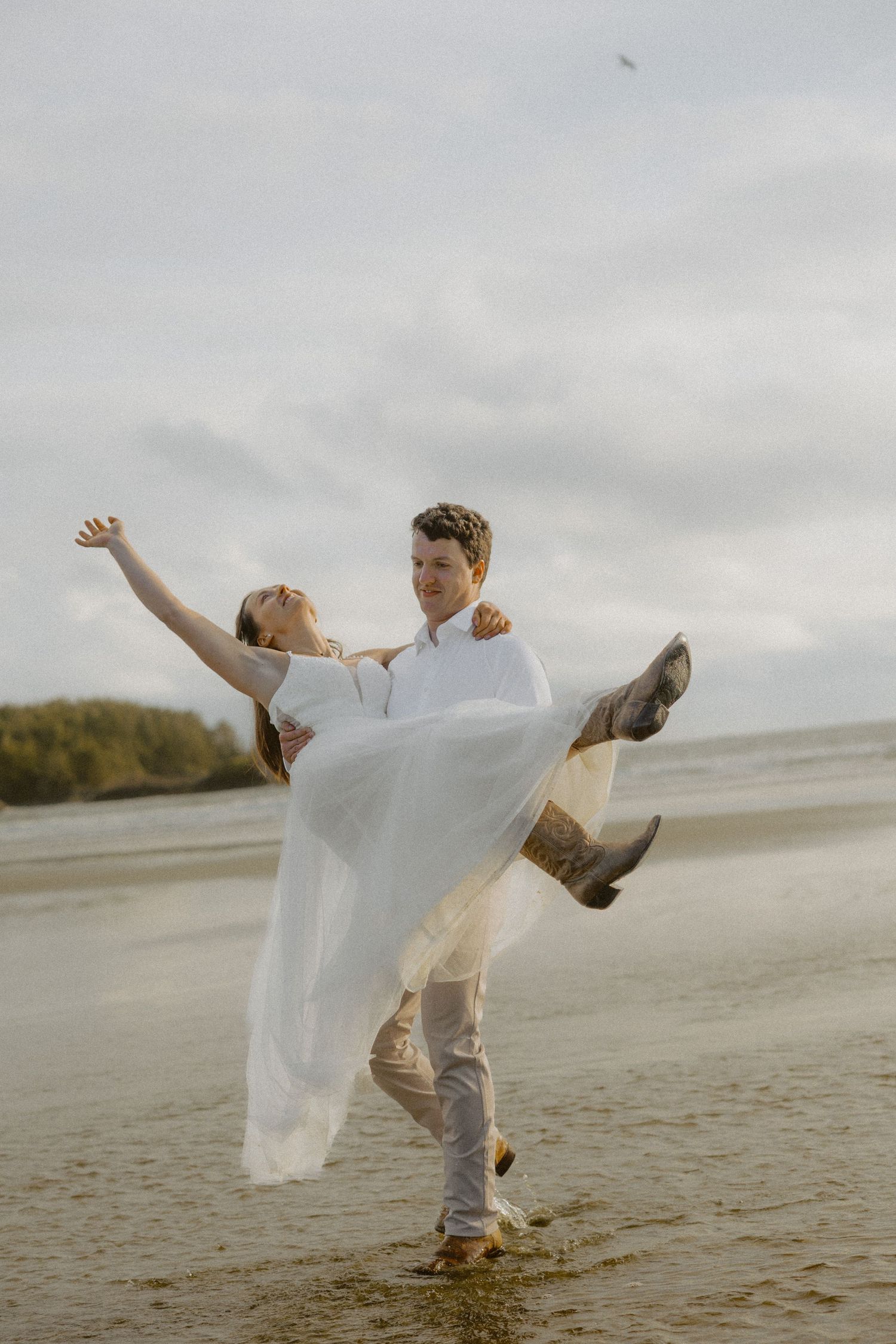 Tofino elopement couple dancing and twirling on the beach