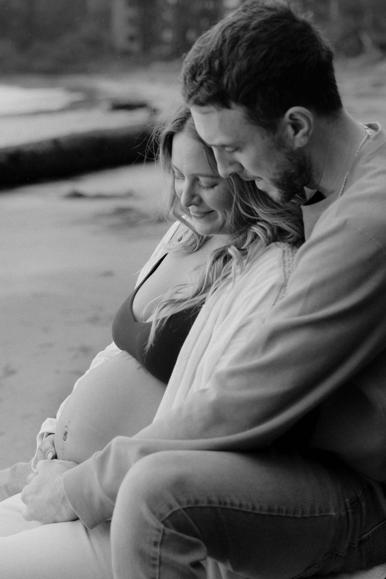 Black and white photo of a couple sharing an intimate moment.