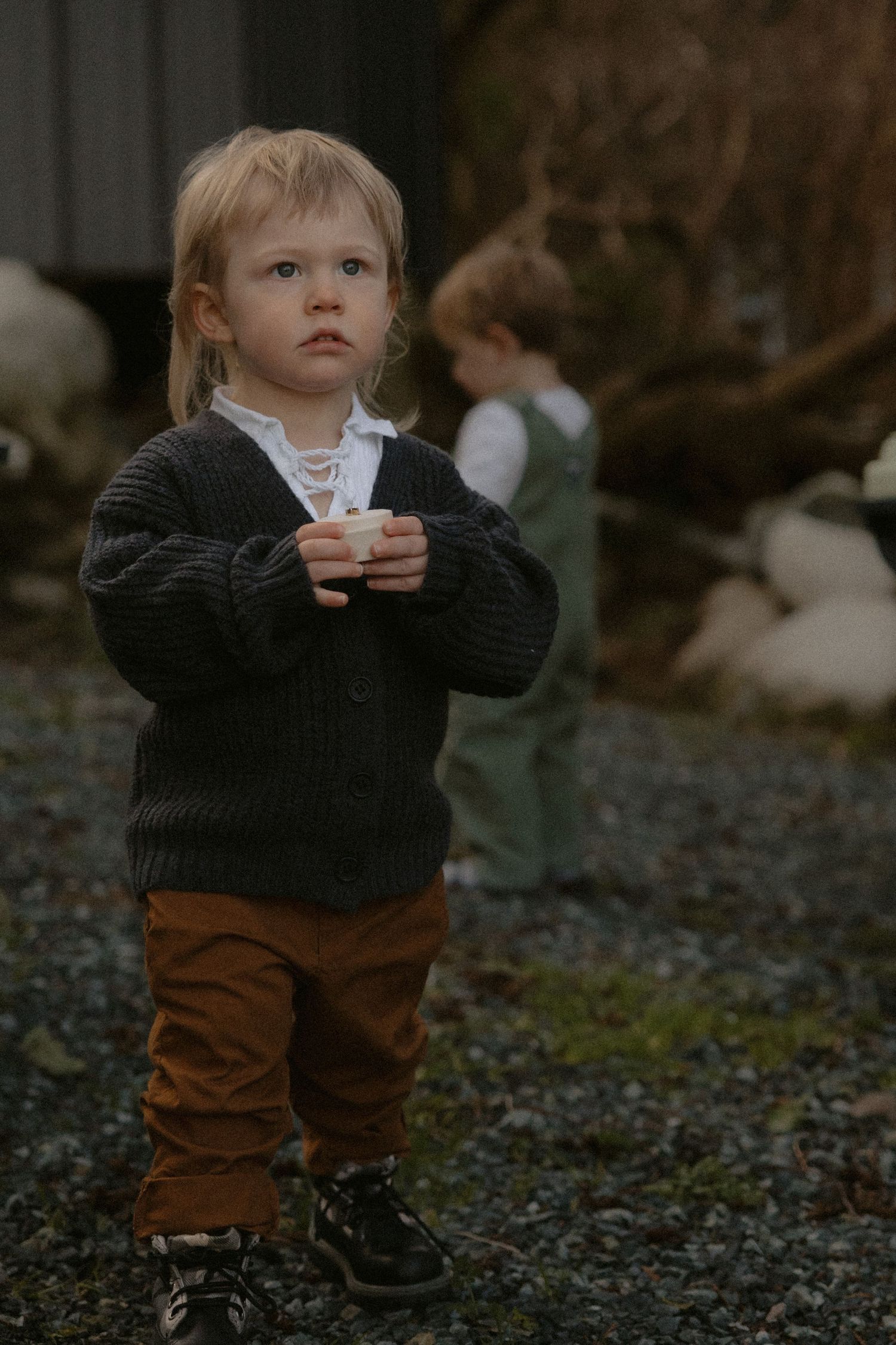 Tofino intimate wedding toddler in a dark sweater bringing the couples' rings to the altar