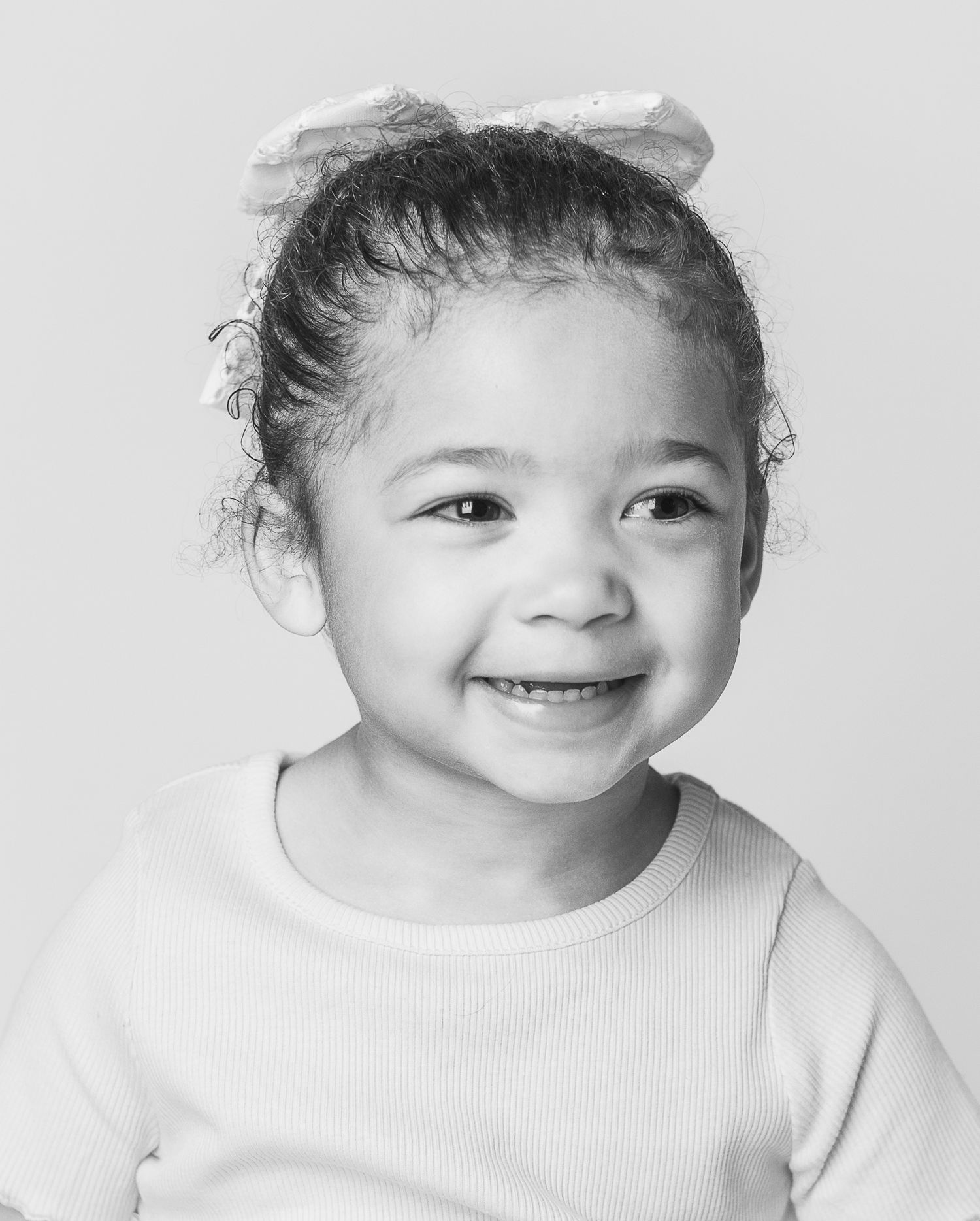 A classic personality portrait of a little girl laughing captured by Northeast Ohio's best personality portrait photographer, FRAMED.