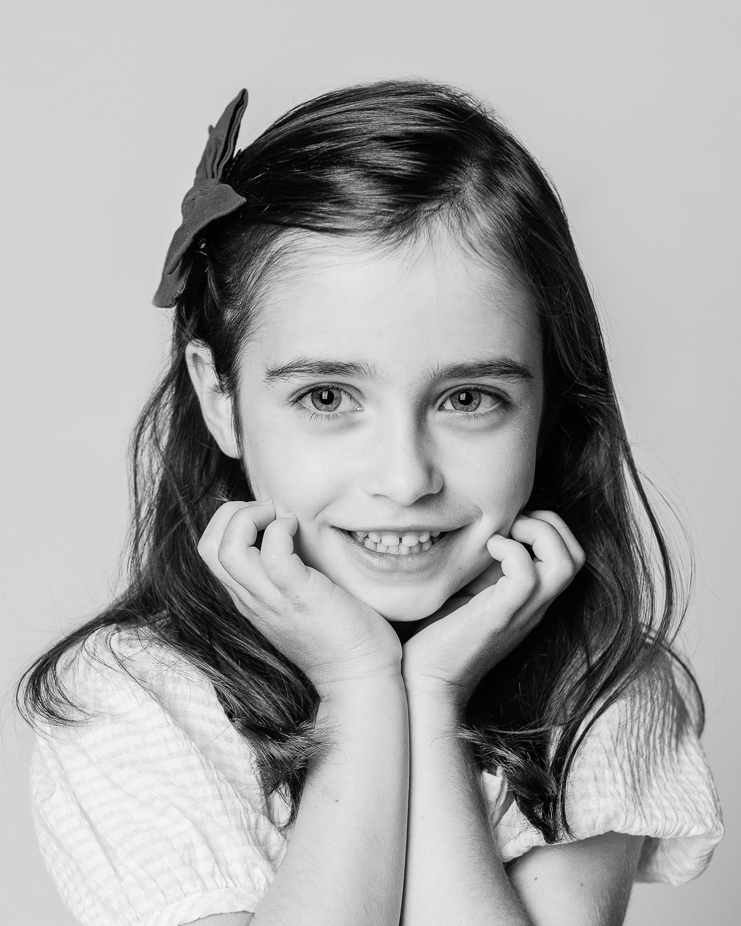 A timeless black and white photograph of a young girl captured by the Cleveland areas best personality portrait photographer, FRAMED.