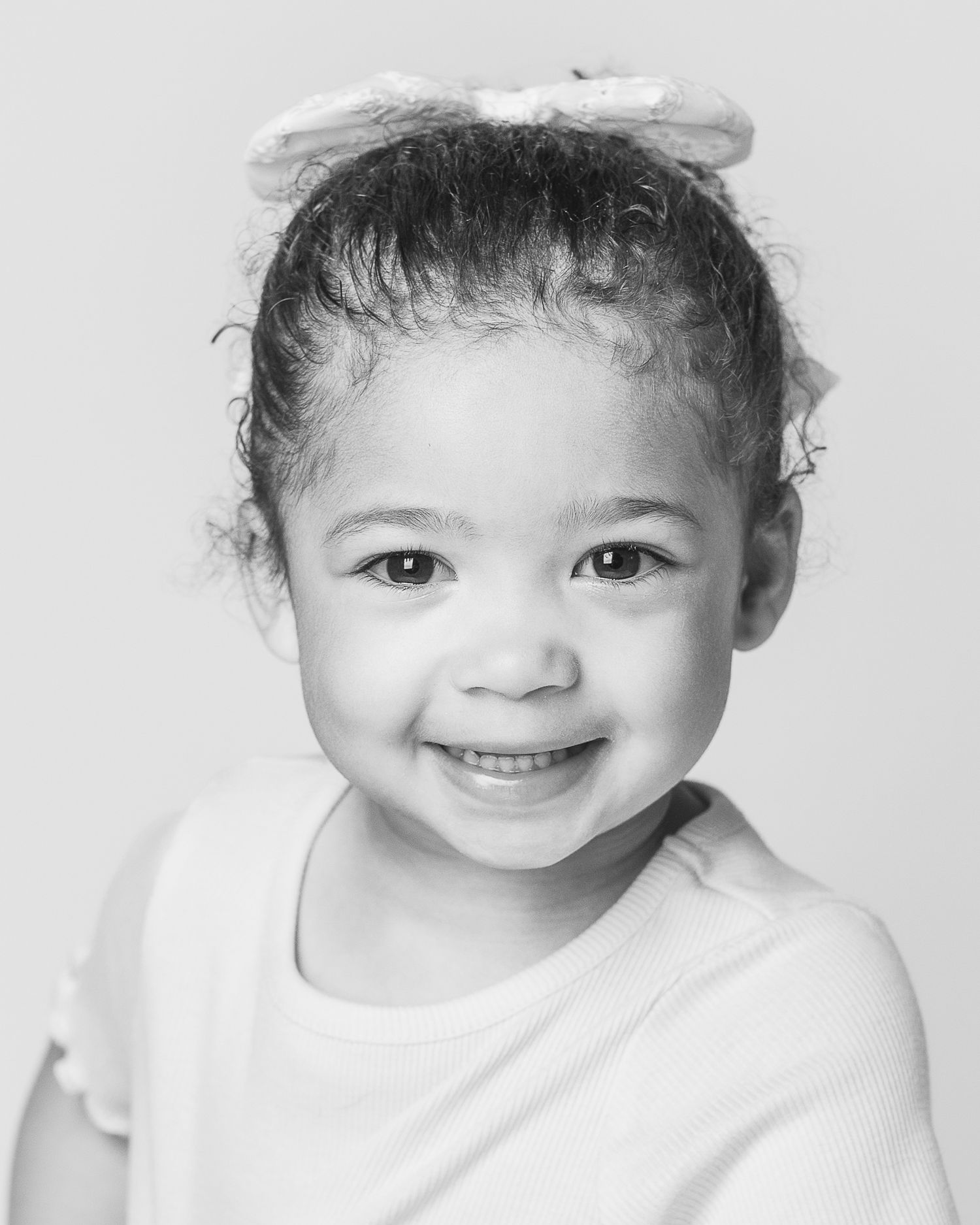 A sweet photograph of a toddler girl captured during a personality portrait session by Ohio photographer, FRAMED.