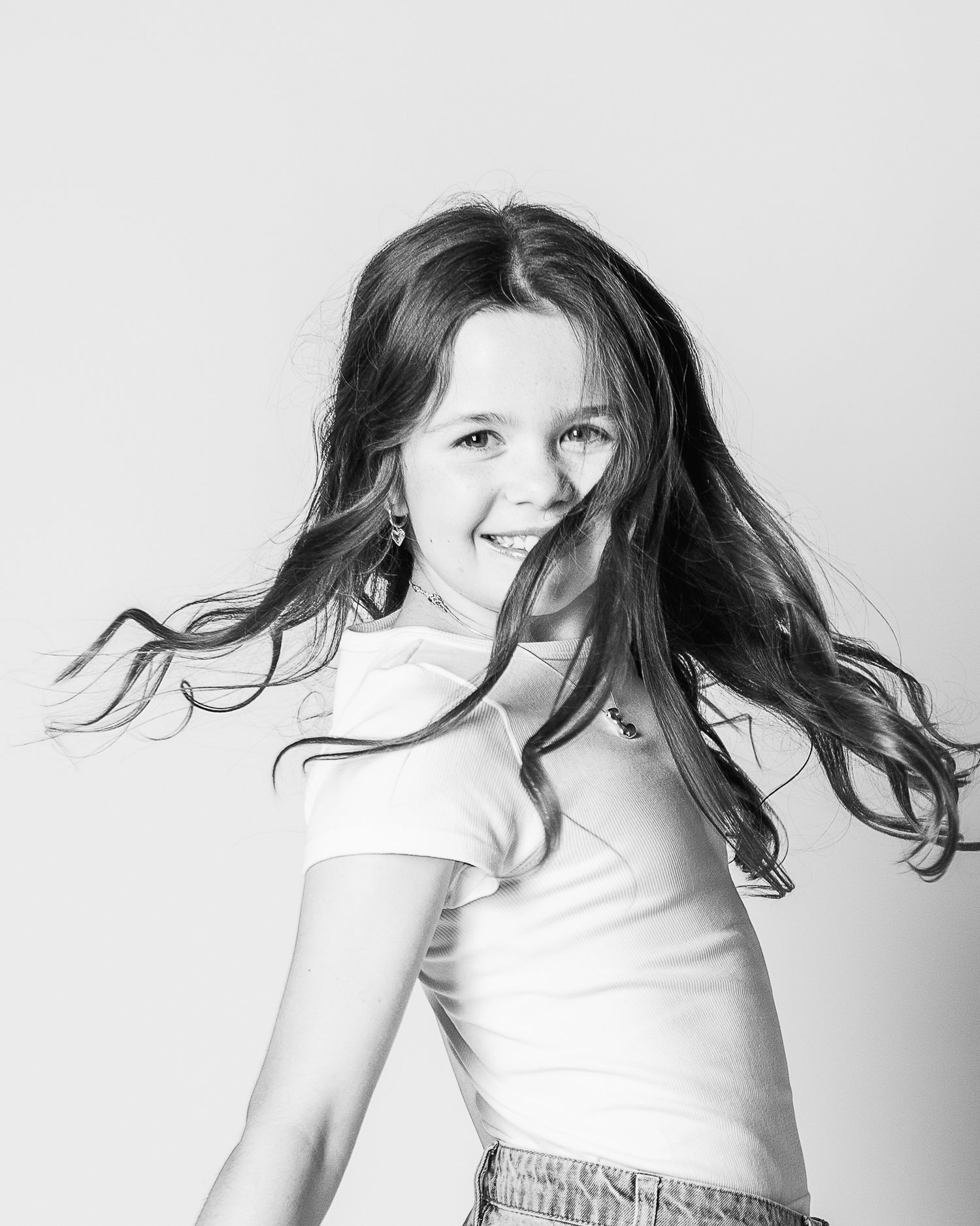 A fun portrait capturing the personality of a girl twirling and her hair flying by Ohio's personality portrait photographer, FRAMED.
