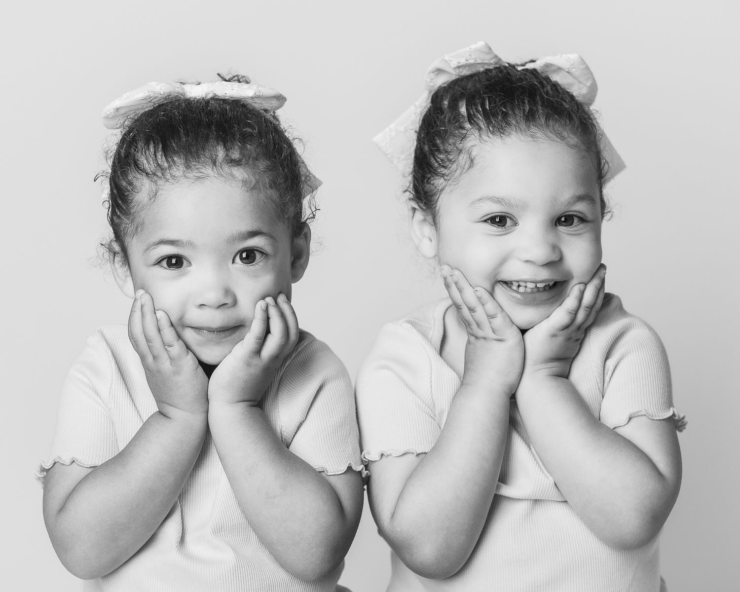 A timeless black and white portrait of twin sisters during a studio portrait session by Ohio photographer, FRAMED.