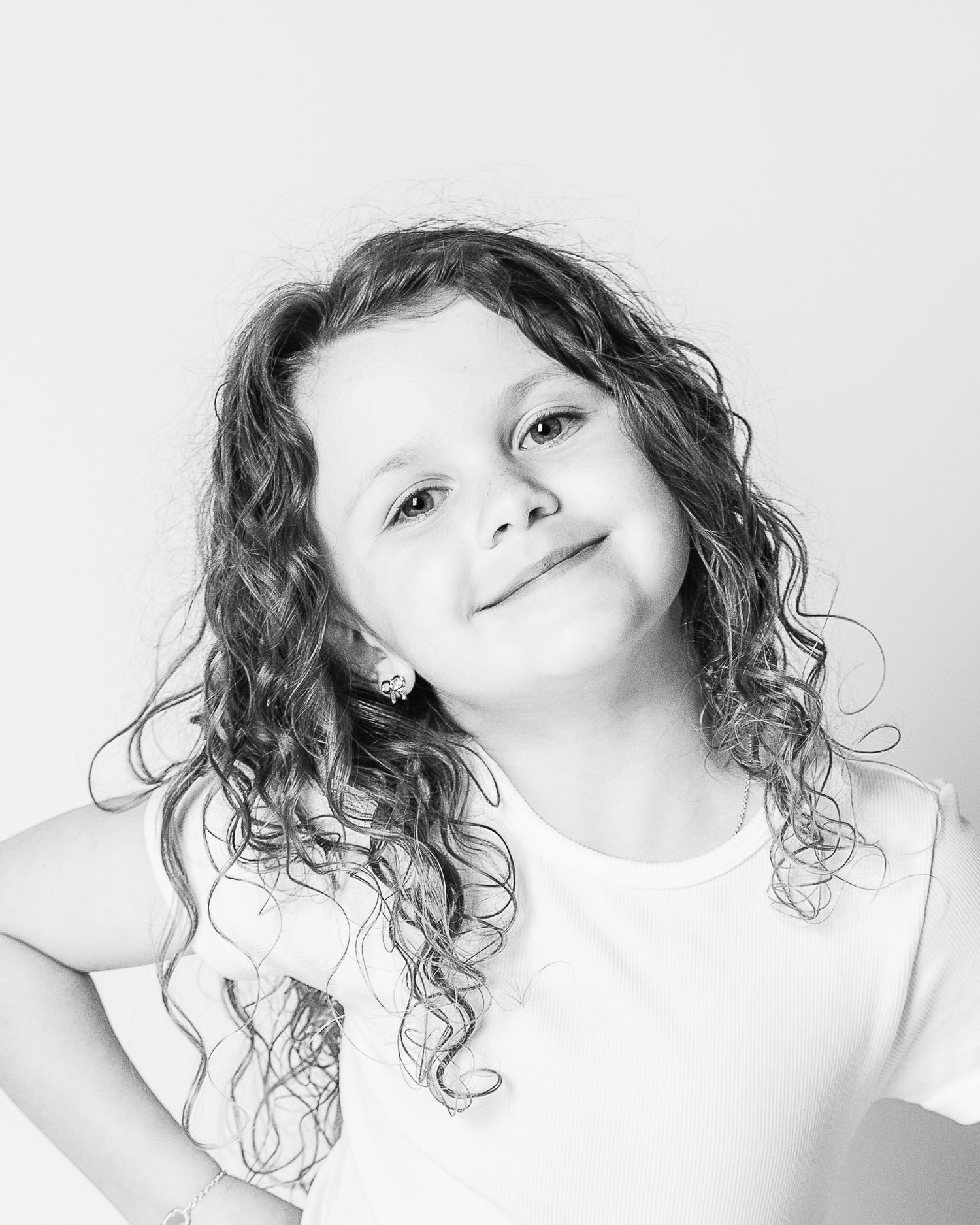 A timeless black and white portrait capturing the fun and sassy personality of a young girl by Northeast Ohio studio portrait photographer.