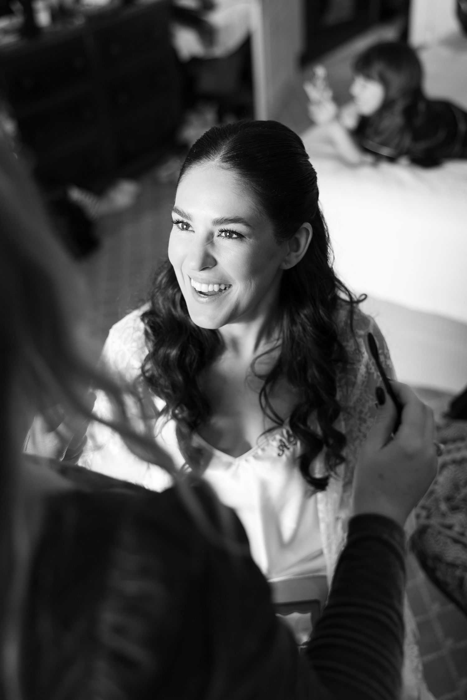 Black and white portraits capturing candid moments during wedding preparations.