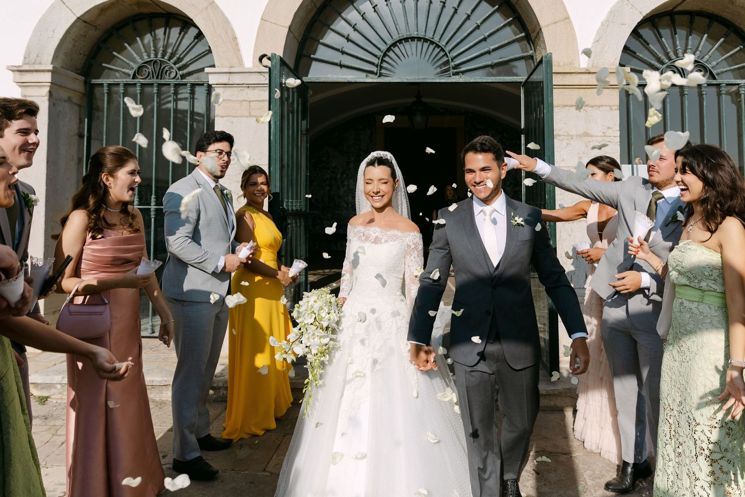 Wedding party guests mingle and celebrate during an outdoor reception.