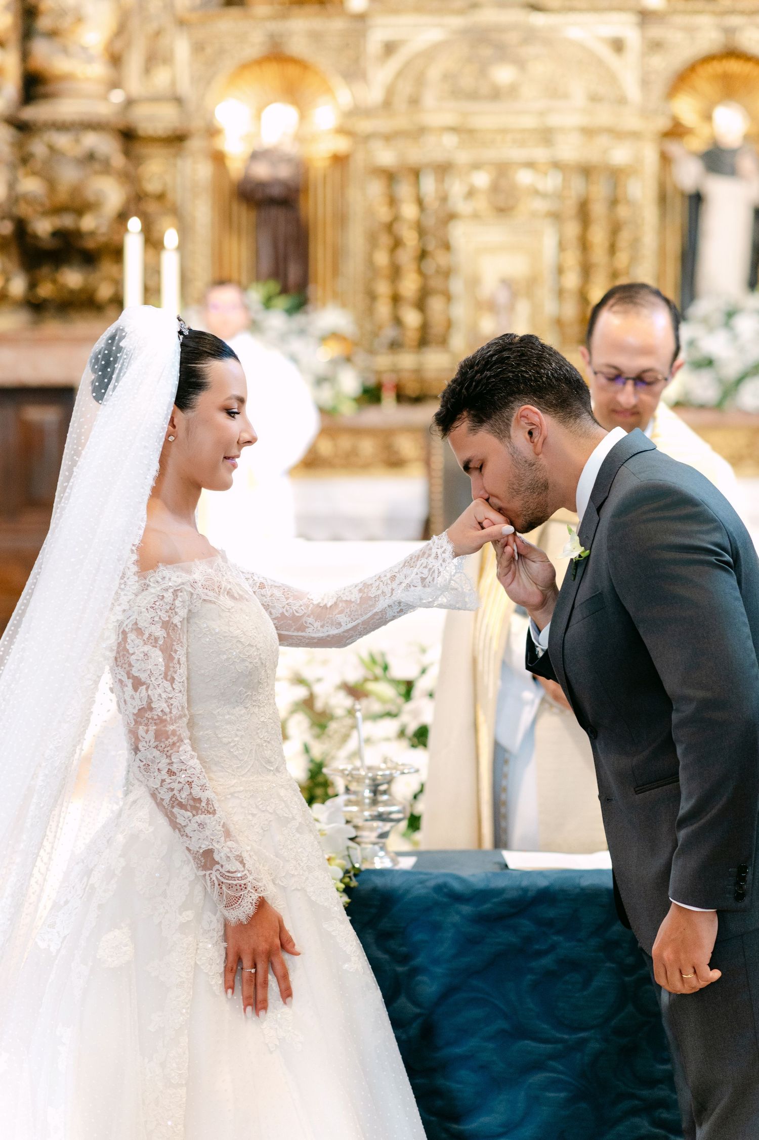 Traditional wedding ceremony taking place in a beautifully decorated church.