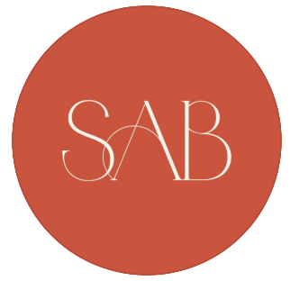 Elegant SAB monogram logo in cream letters on a terracotta red circle background.