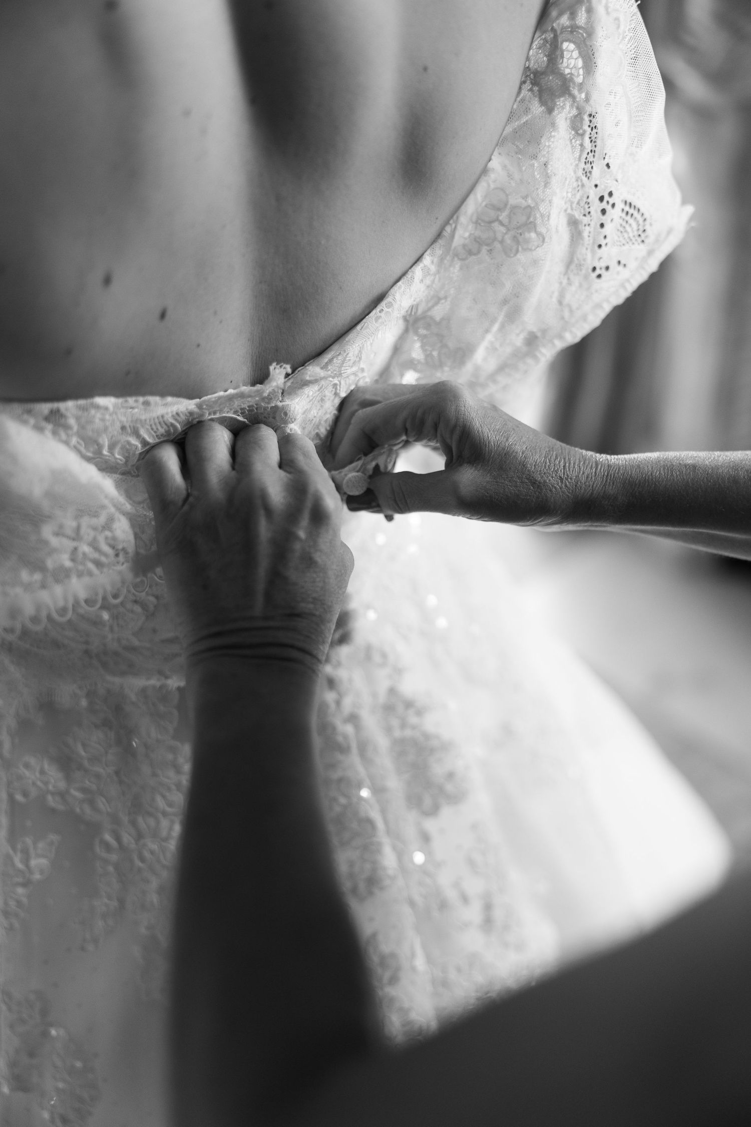 Close-up detail shot of delicate white lace fabric with intricate patterns.