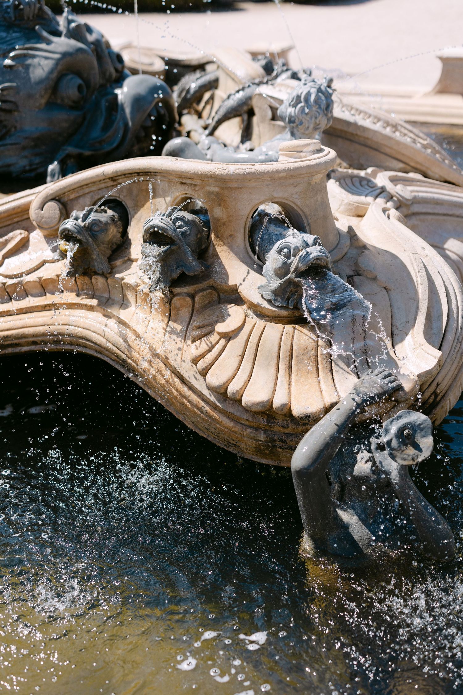 Ornate stone fountain with water splashing in dramatic detail.