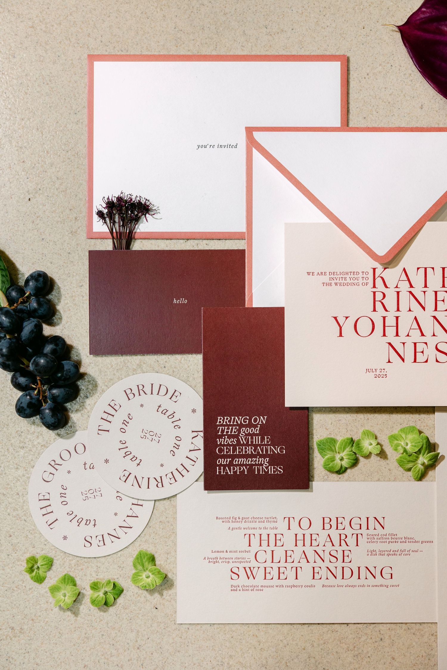 Modern wedding stationery suite in burgundy and blush pink with elegant typography and floral accents.