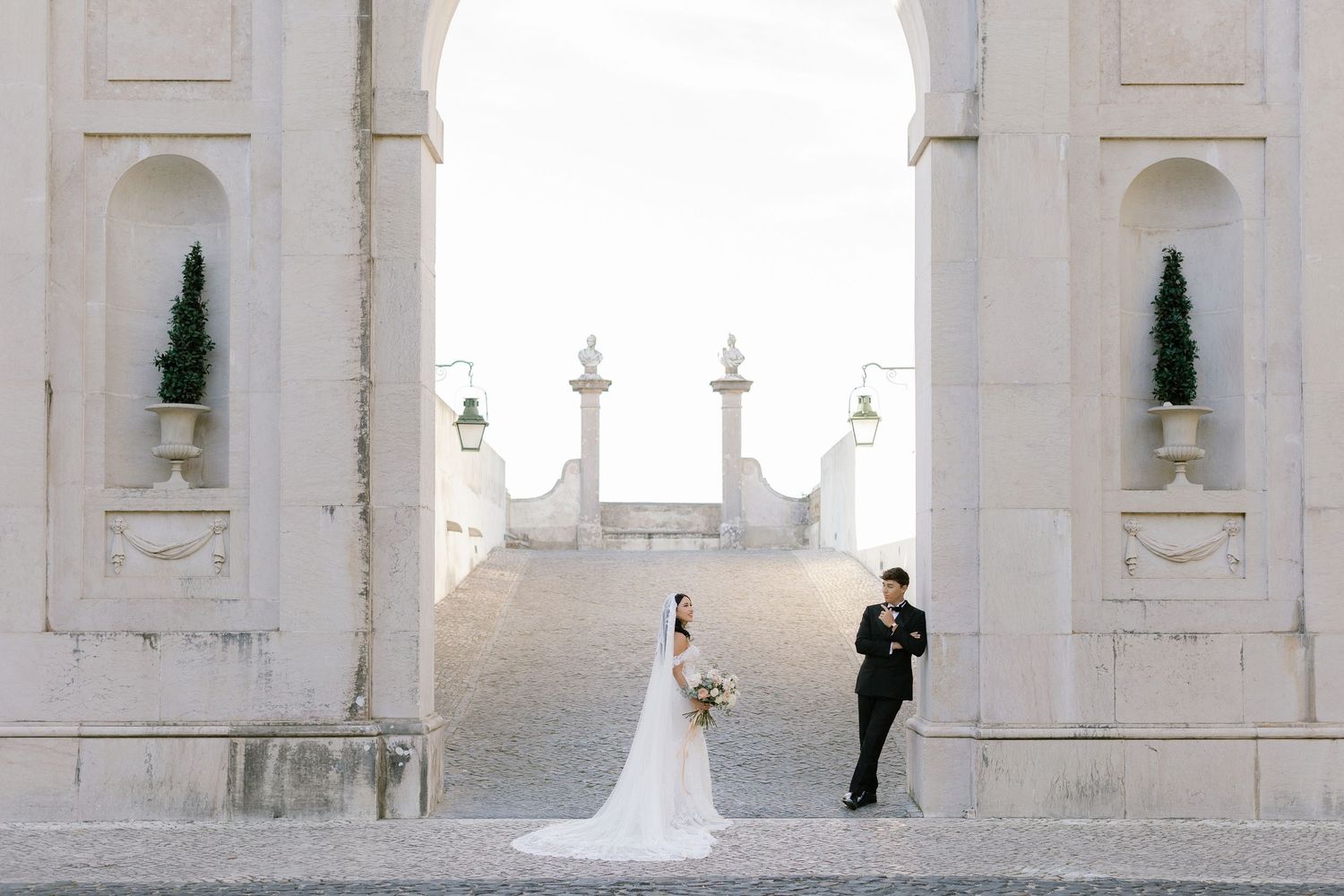 Wedding photography sequence at elegant white archway architecture.