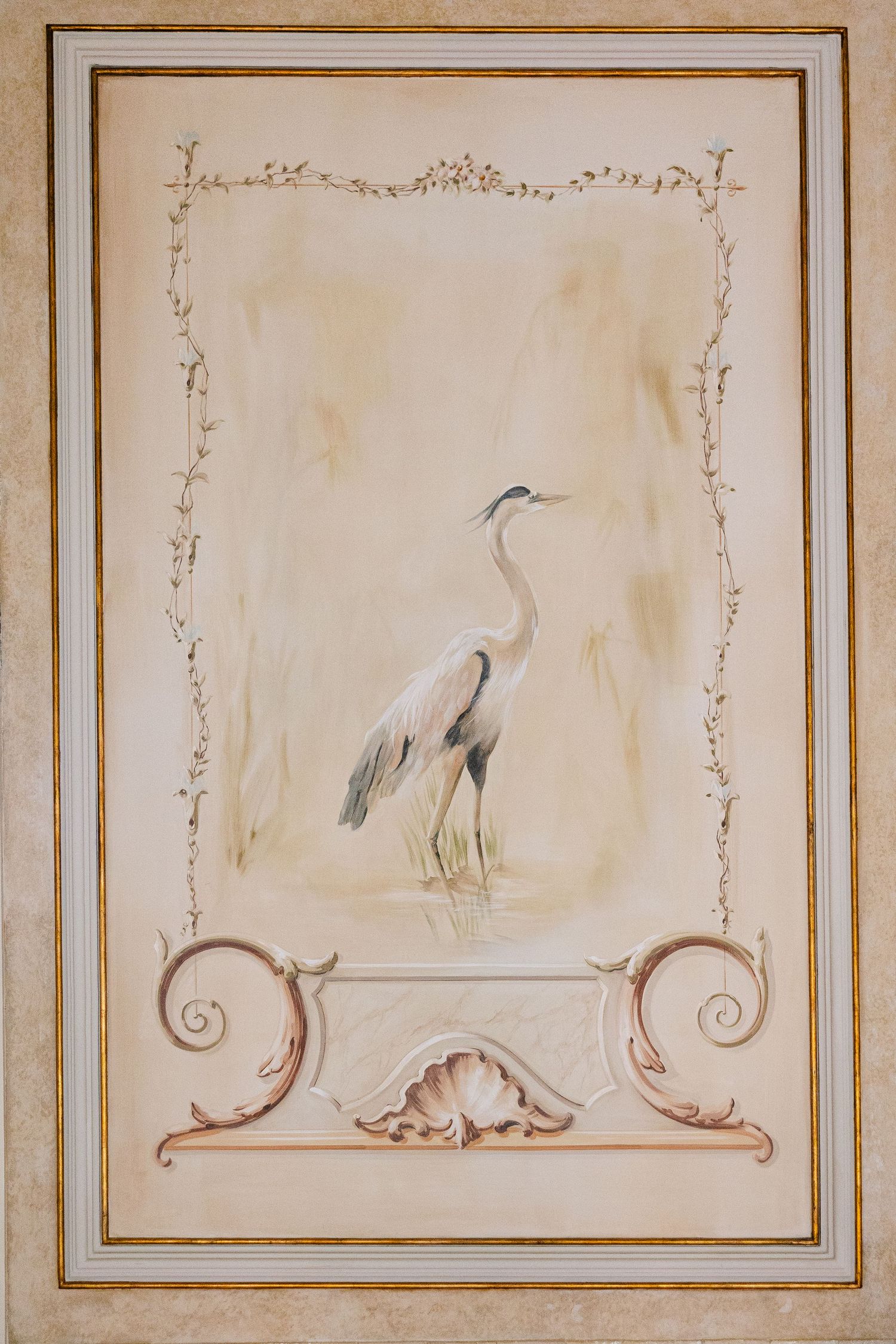 Decorative wall panels with painted bird motifs and gold trim in a classical style.