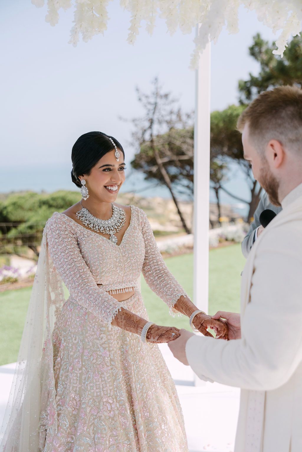 Wedding ceremony on a lawn with guests celebrating a joyful moment.