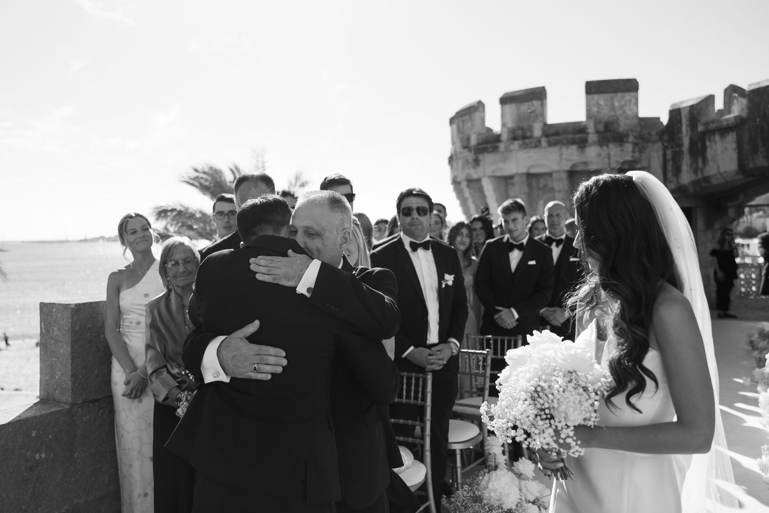 Wedding guests mingle and socialize during an outdoor reception.