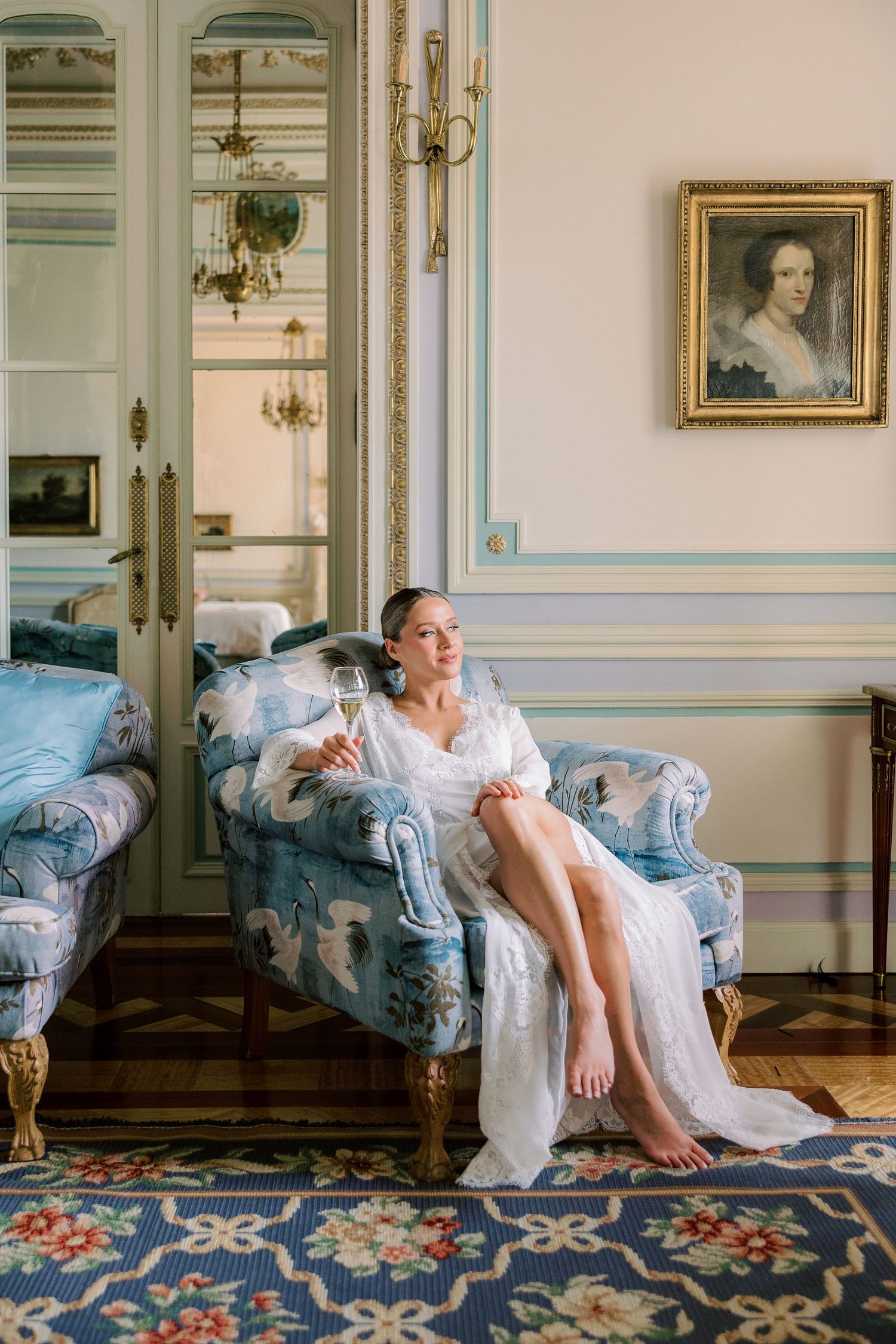 Elegant bridal portrait in a vintage-style room with ornate furniture and decor.