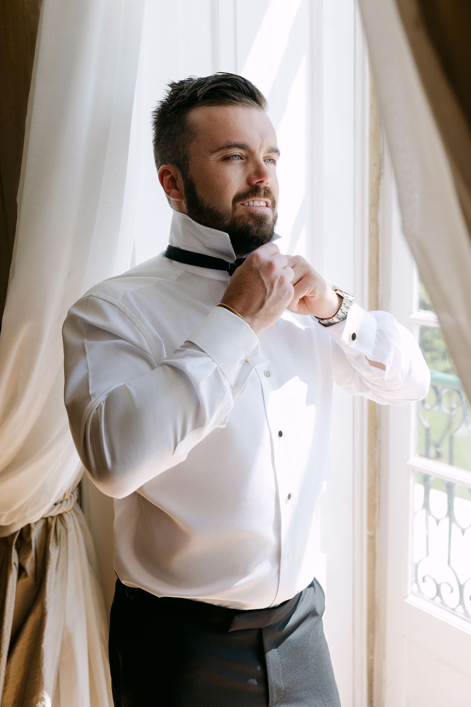 Getting ready sequence showing formal attire preparation by window with curtains.