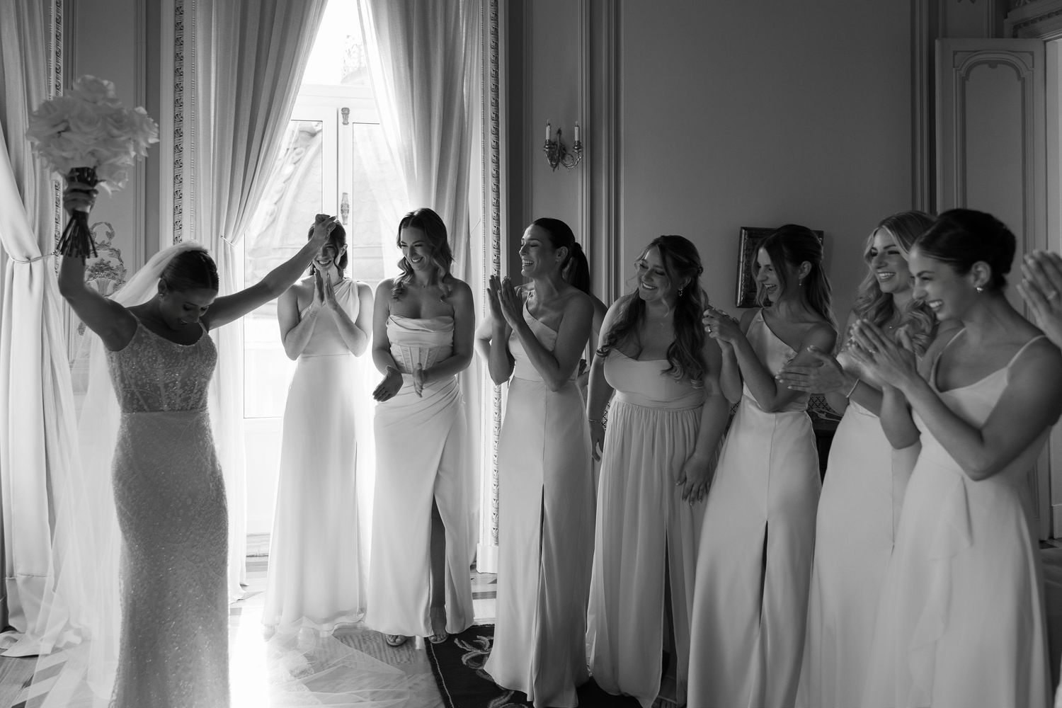 Group photos showing people in white dresses gathered in an elegant room.