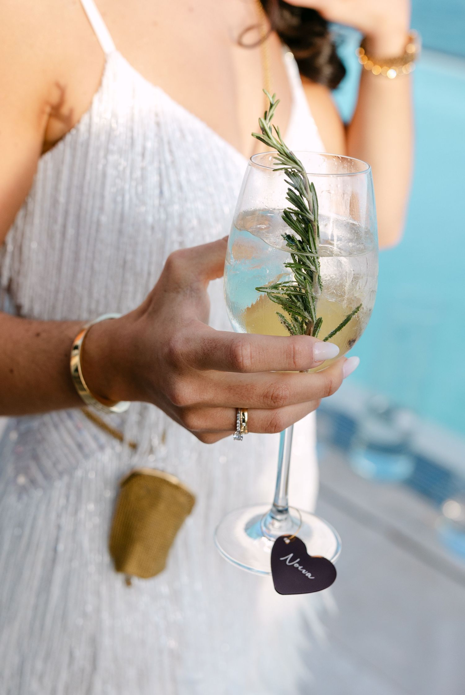 Elegant wedding drinks garnished with fresh herbs and served in champagne glasses.