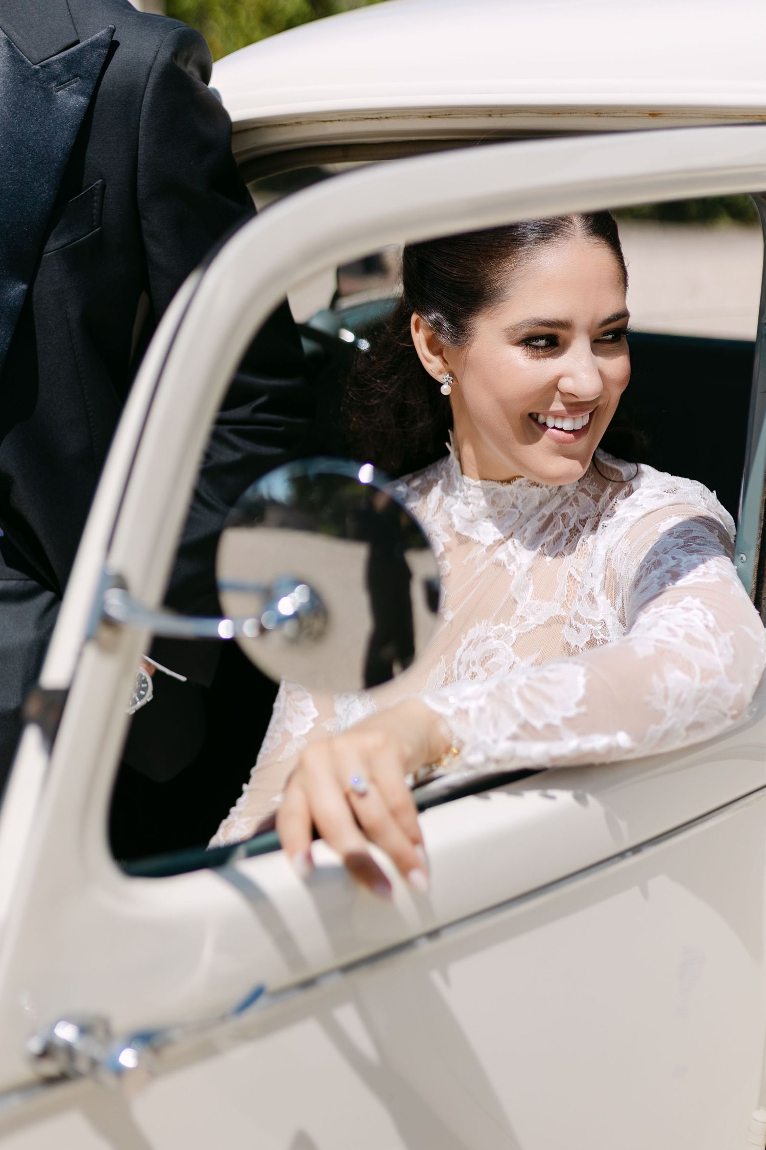 Sequence of shots showing a bride entering a classic white vintage car.