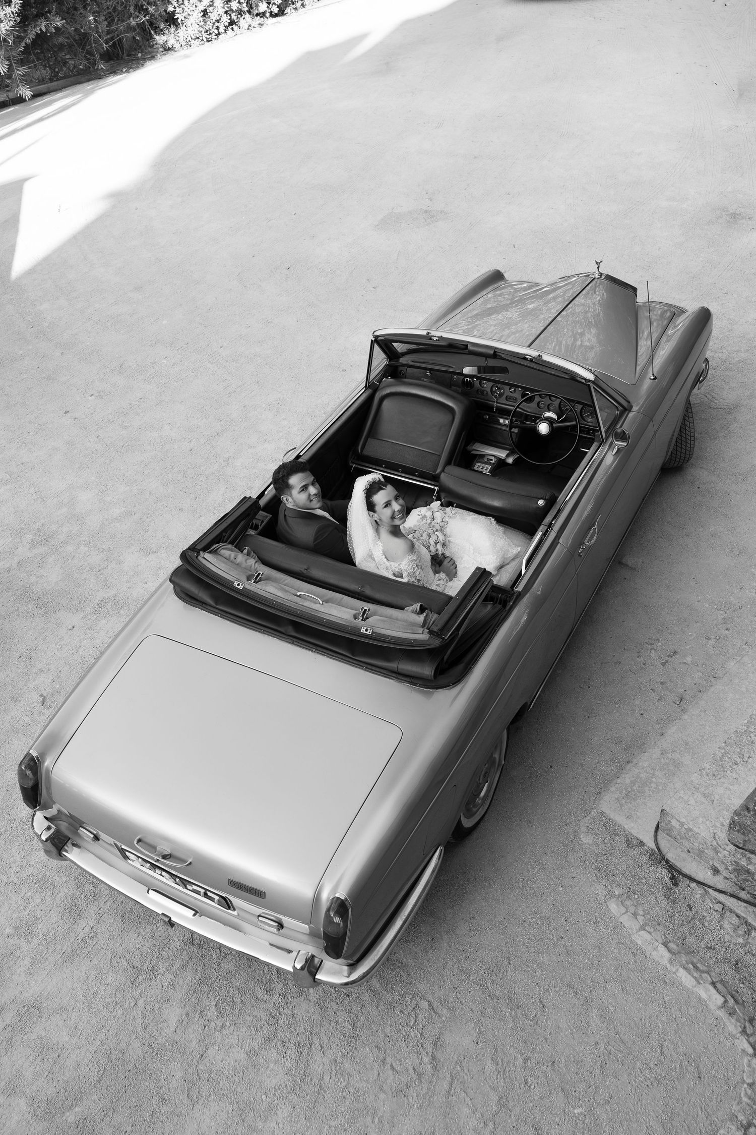 Vintage silver convertible car photographed from above at a wedding venue.