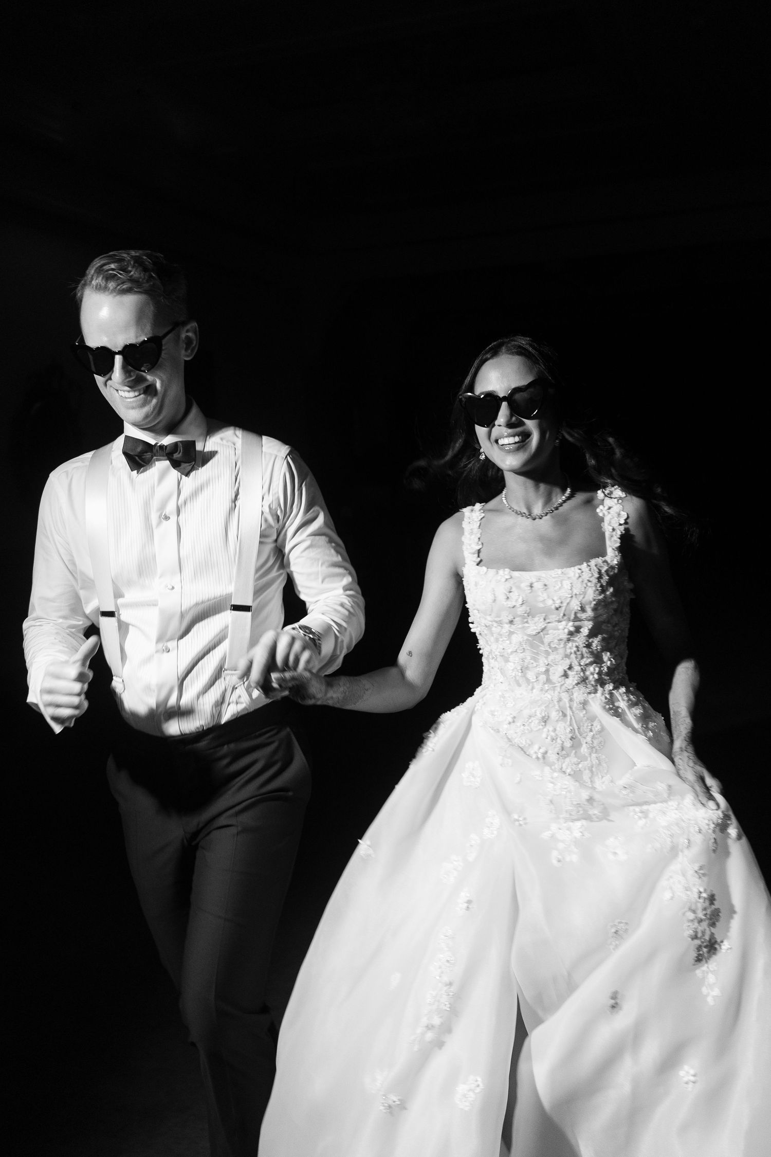 Artistic black and white portrait of a couple in wedding attire.