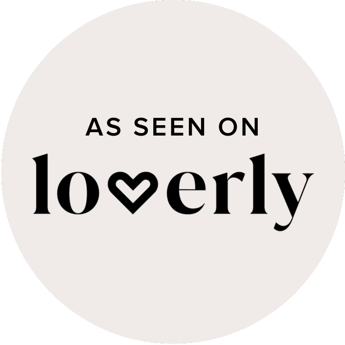 As seen on Loverly badge, a circular emblem with black text on a light beige background featuring a heart in the logo.
