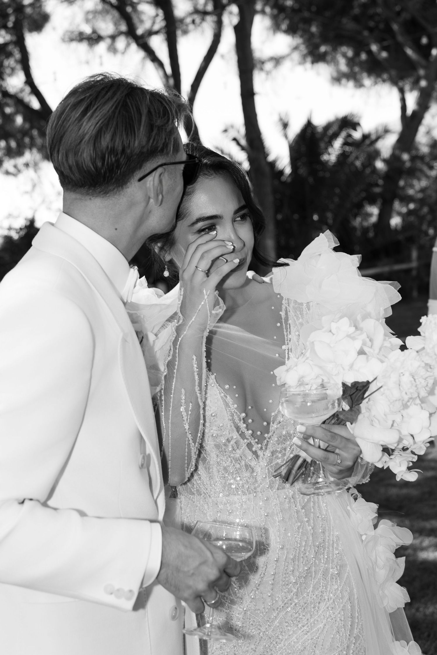 Artistic black and white photos of couple with flowing fabric outdoors.