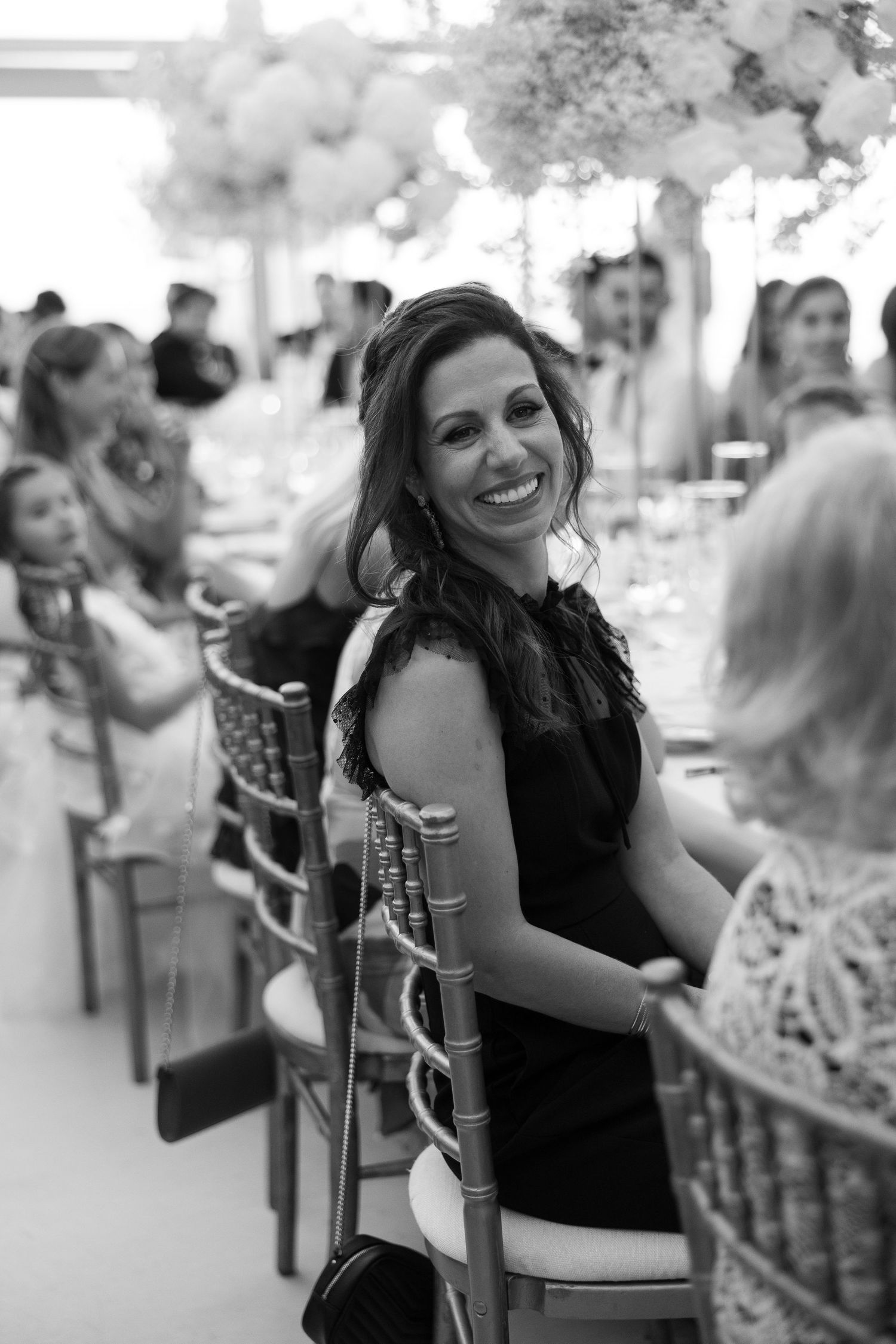 Black and white photo of wedding guests enjoying a festive celebration.