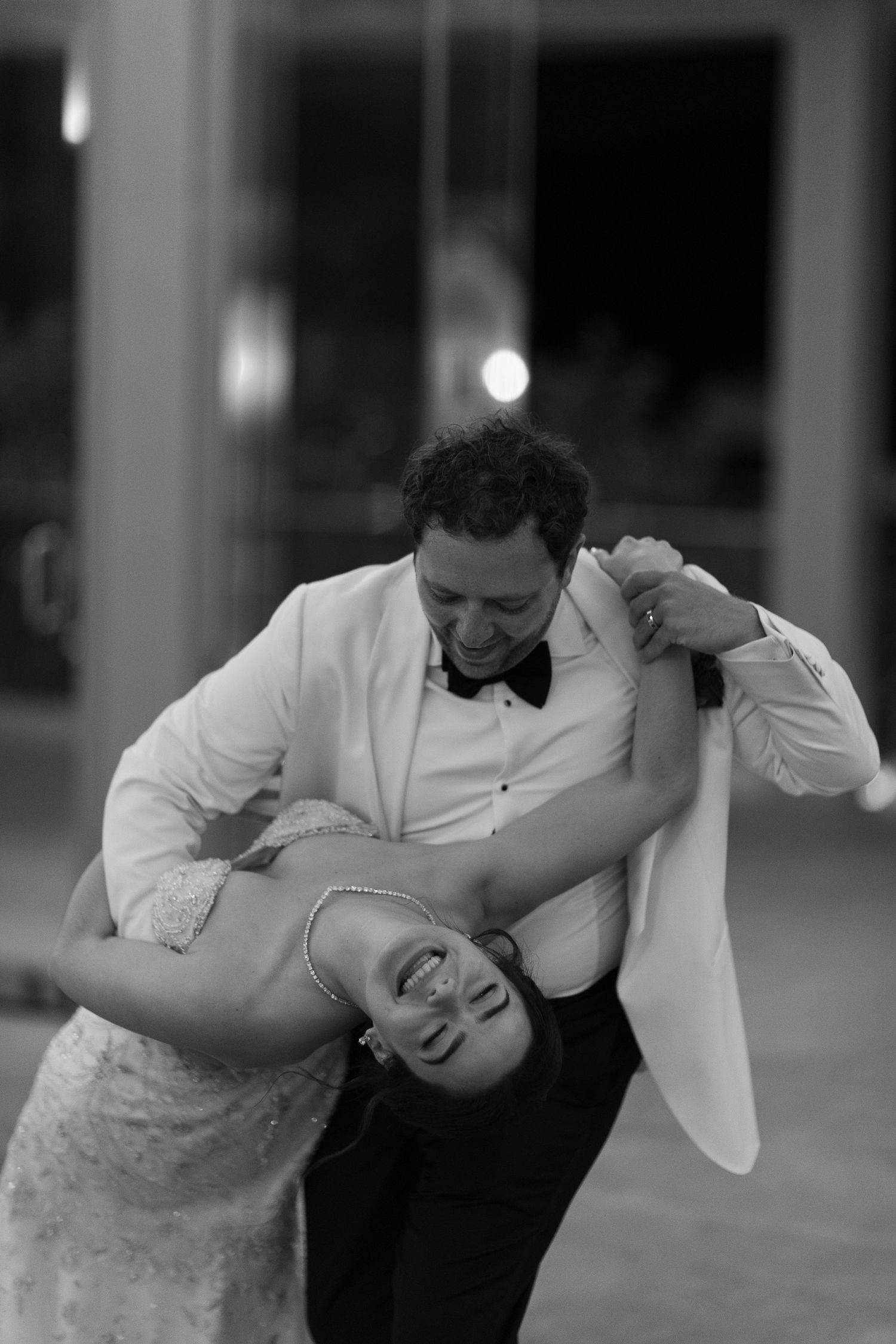 Couple dancing in formal attire at an elegant event.