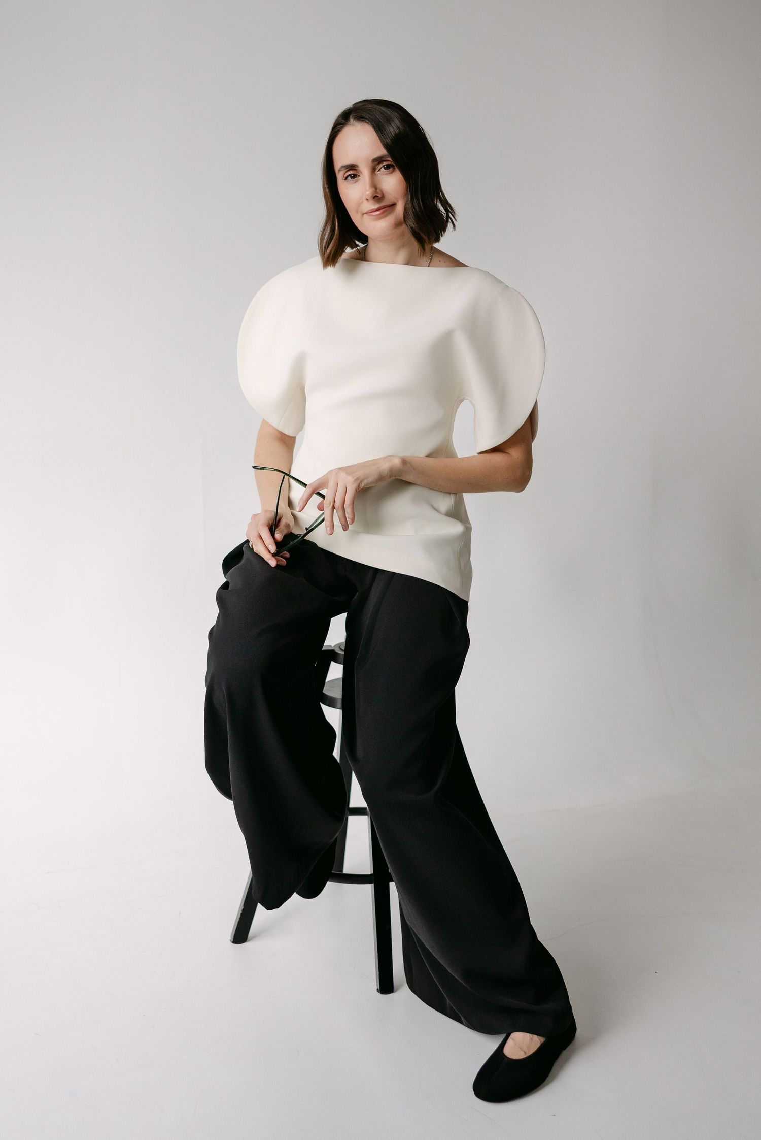 Studio portraits showing a minimalist black and white outfit combination with elegant styling.