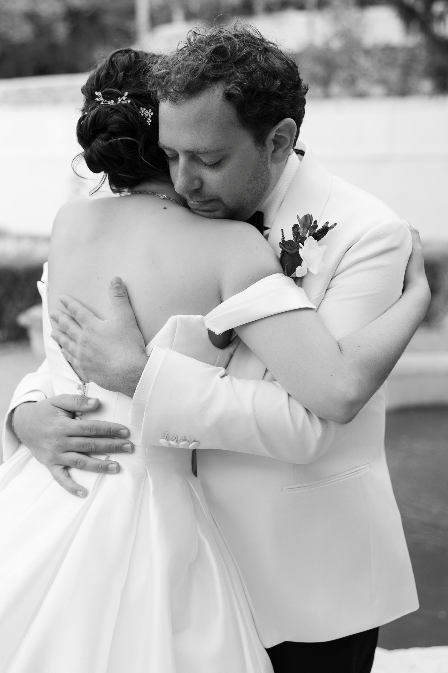 Intimate black and white wedding photography sequence showing tender embraces between newlyweds.