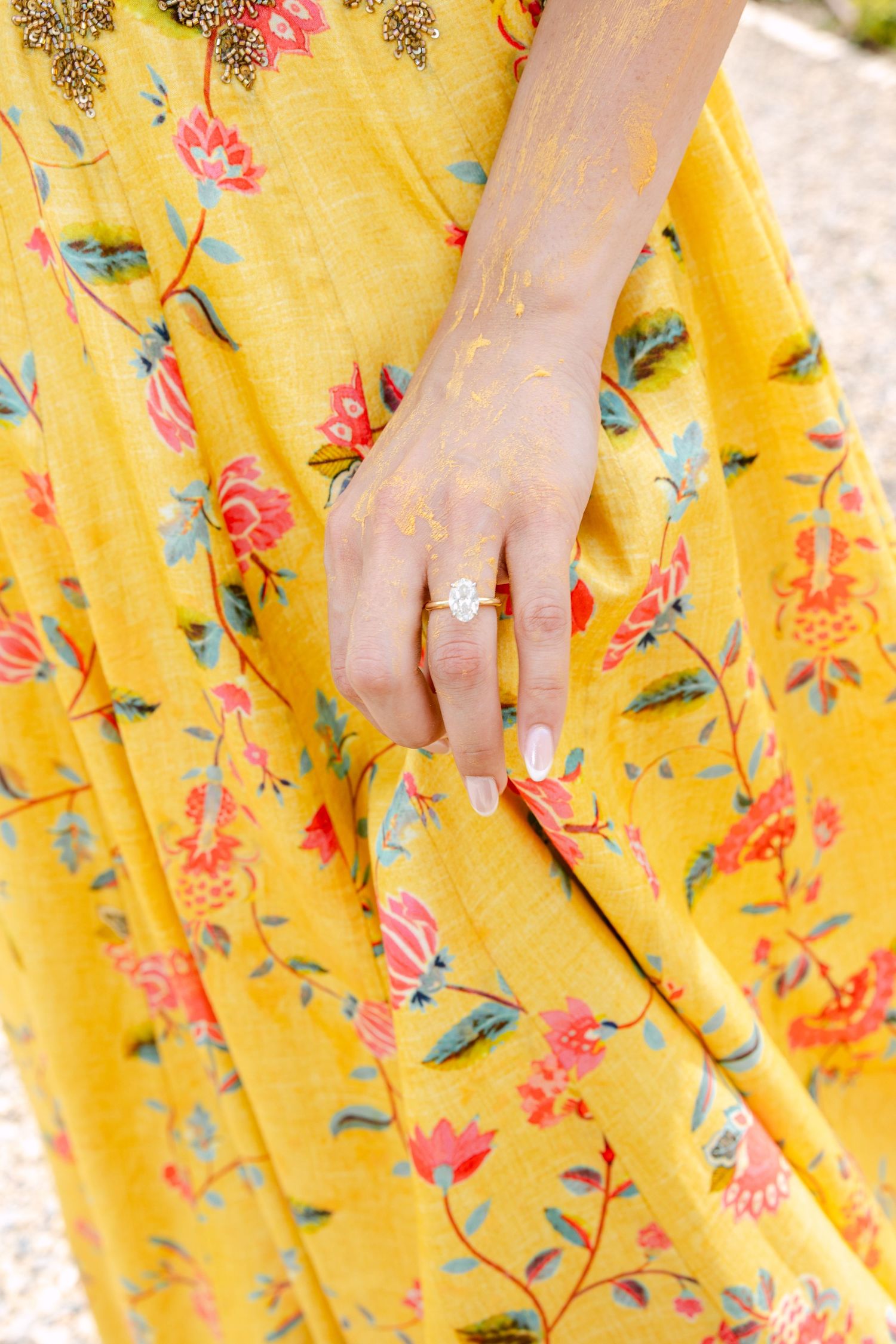 Close-up details of yellow floral fabric with pink and green botanical prints.