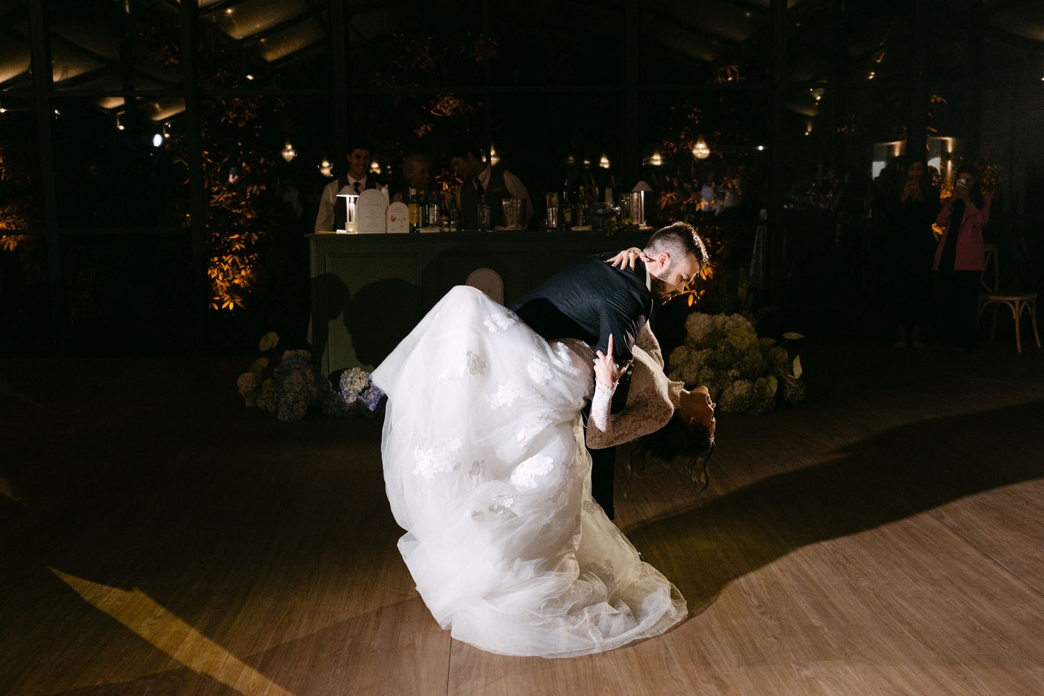Romantic first dance sequence of newlyweds on a dimly lit dance floor.
