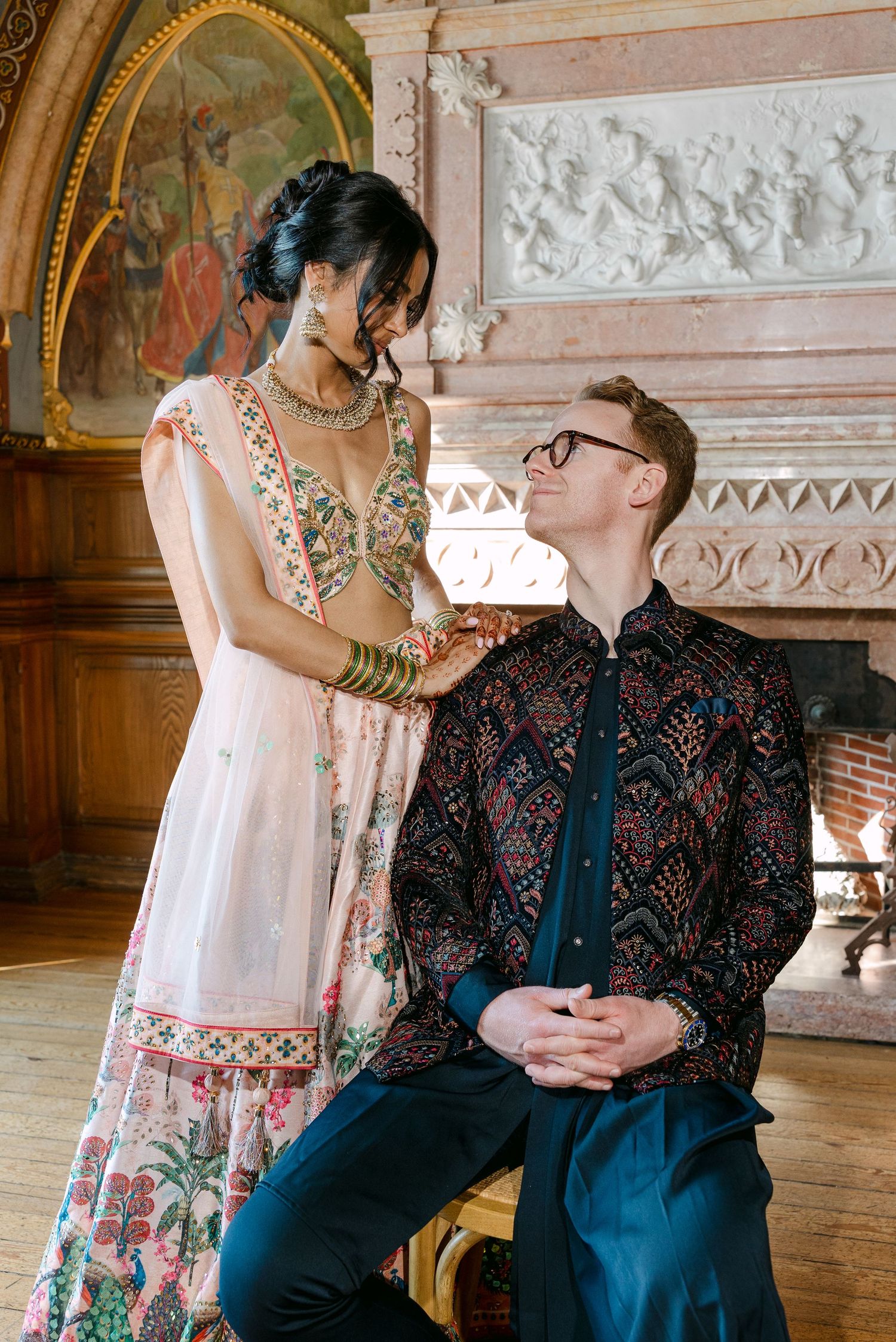 Intimate moment captured in an ornate room with classical architectural details.
