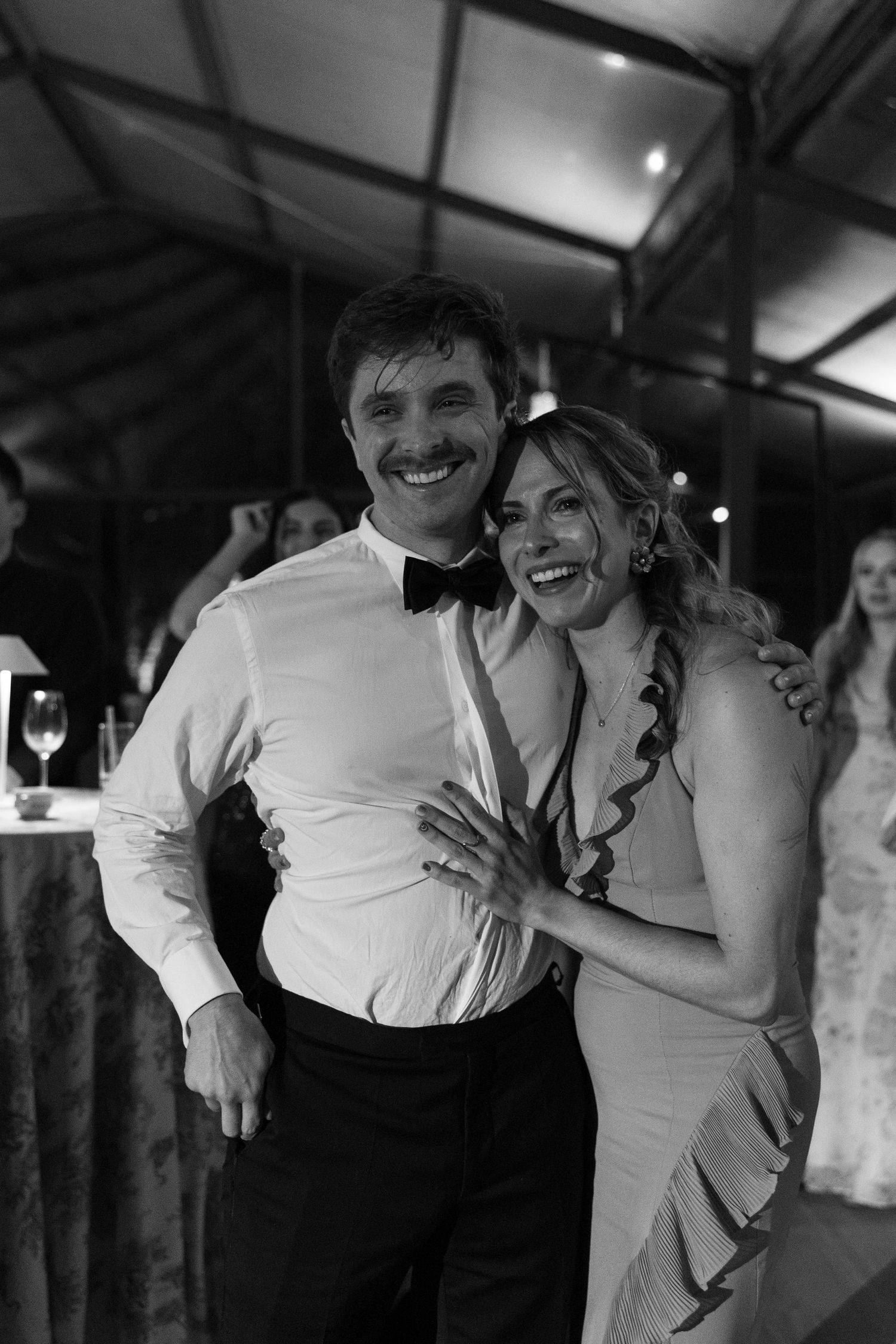 Black and white sequence of joyful dancing at a wedding reception.