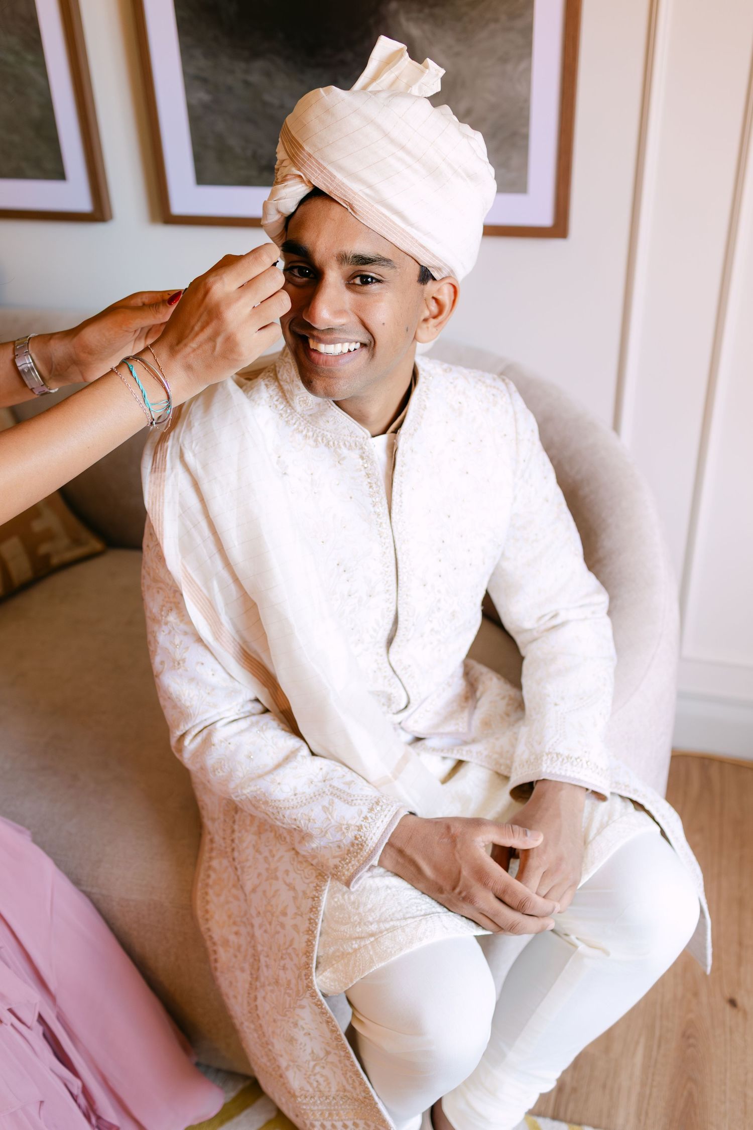 Wedding preparation moments in white traditional attire and turban.