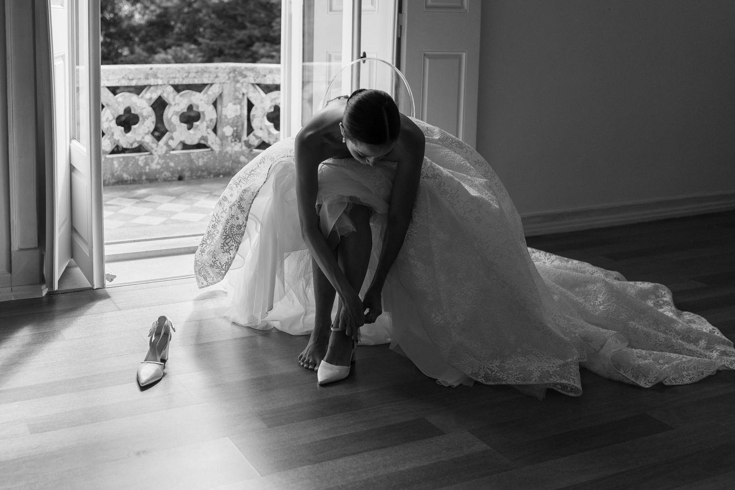 Elegant wedding dress details shown in a series of black and white photographs.