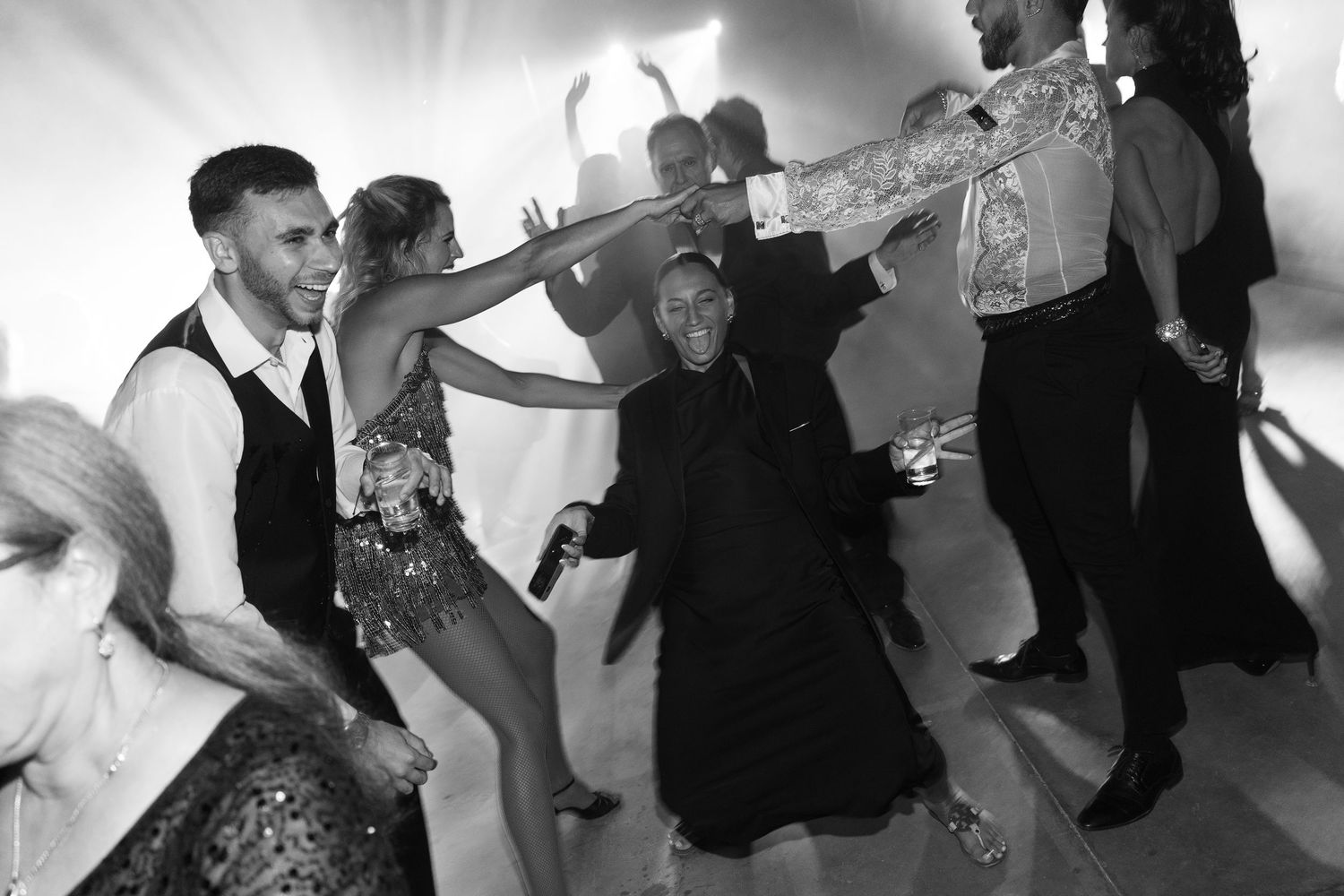 Black and white photos of couples dancing energetically at a formal celebration.